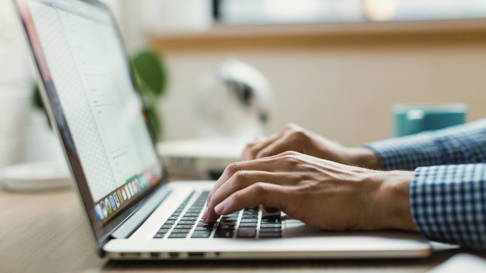 Person typing and reviewing a document on a laptop