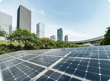 Solar panels with a city skyline and greenery in the background