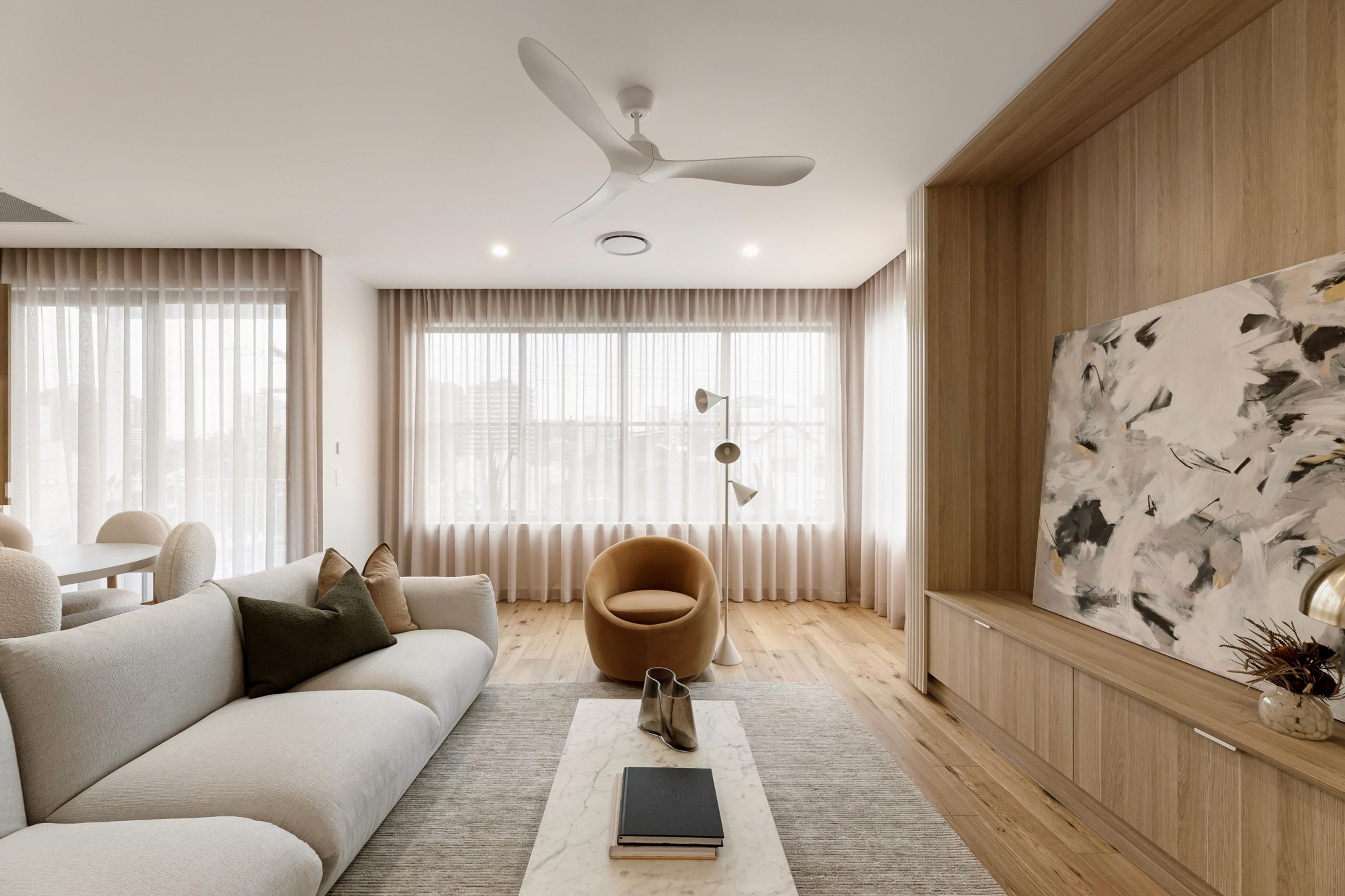Living room with pale sofa, timber panelling and abstract artwork