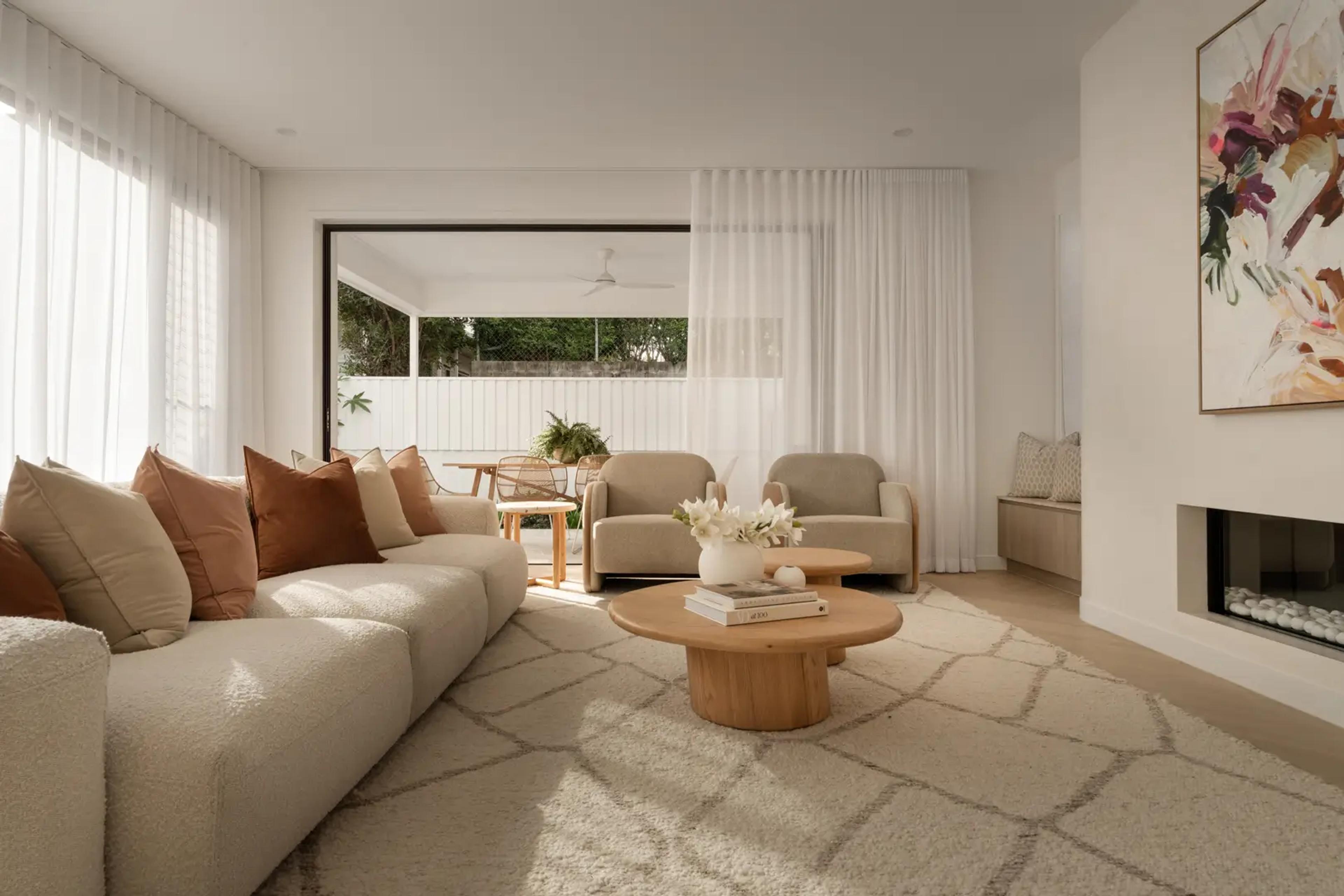 Living room with beige sofa, fireplace and artwork