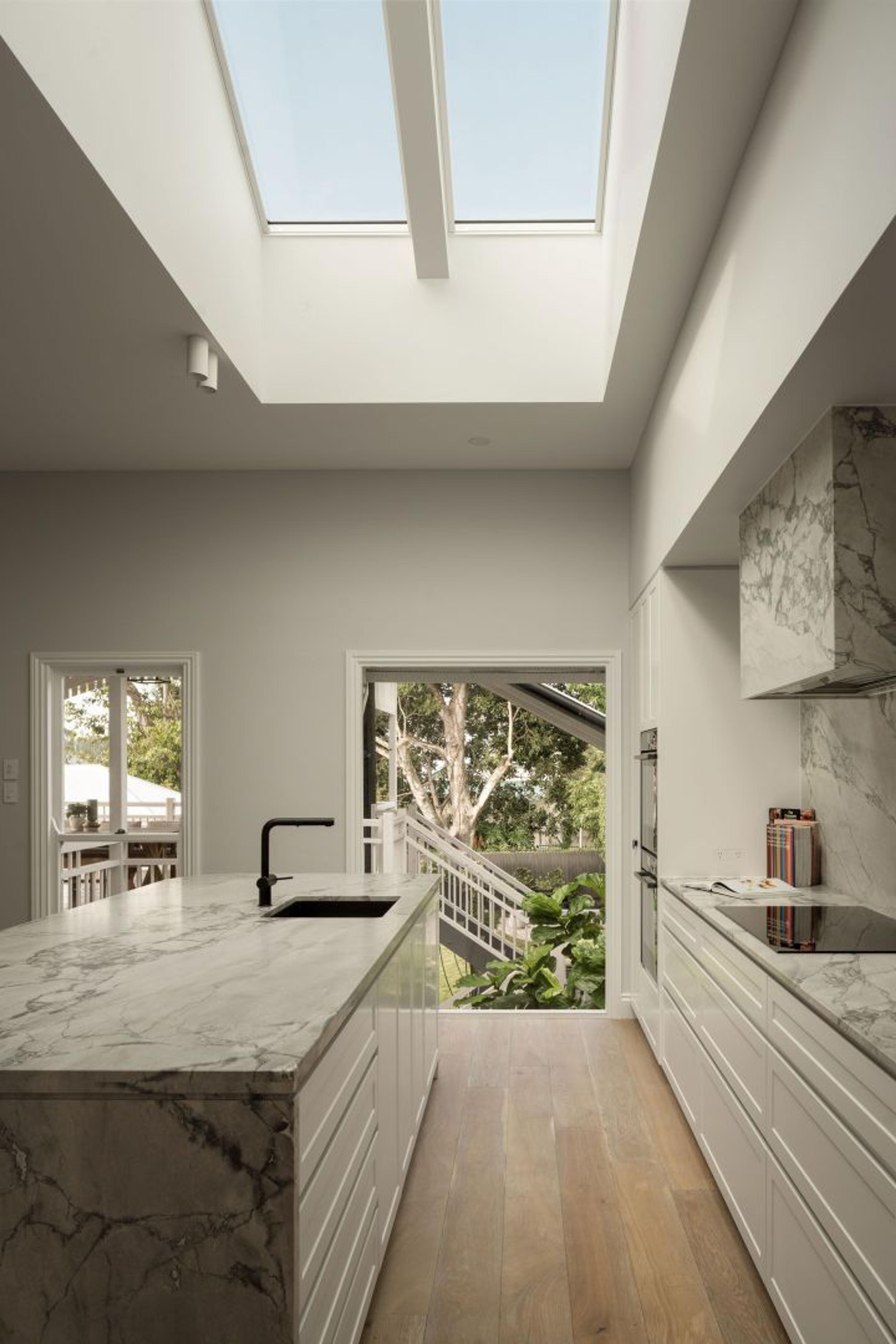 Architectural skylight funnelling natural light into a kitchen.