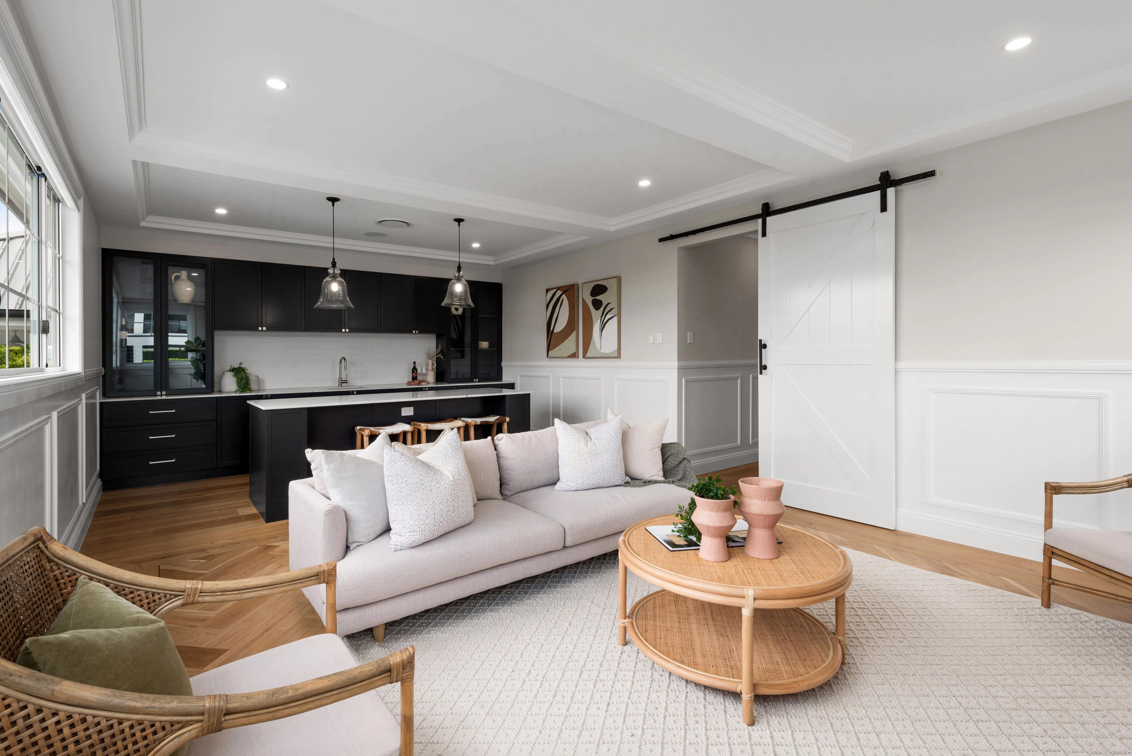 Rumpus lounge with black kitchenette and barn door
