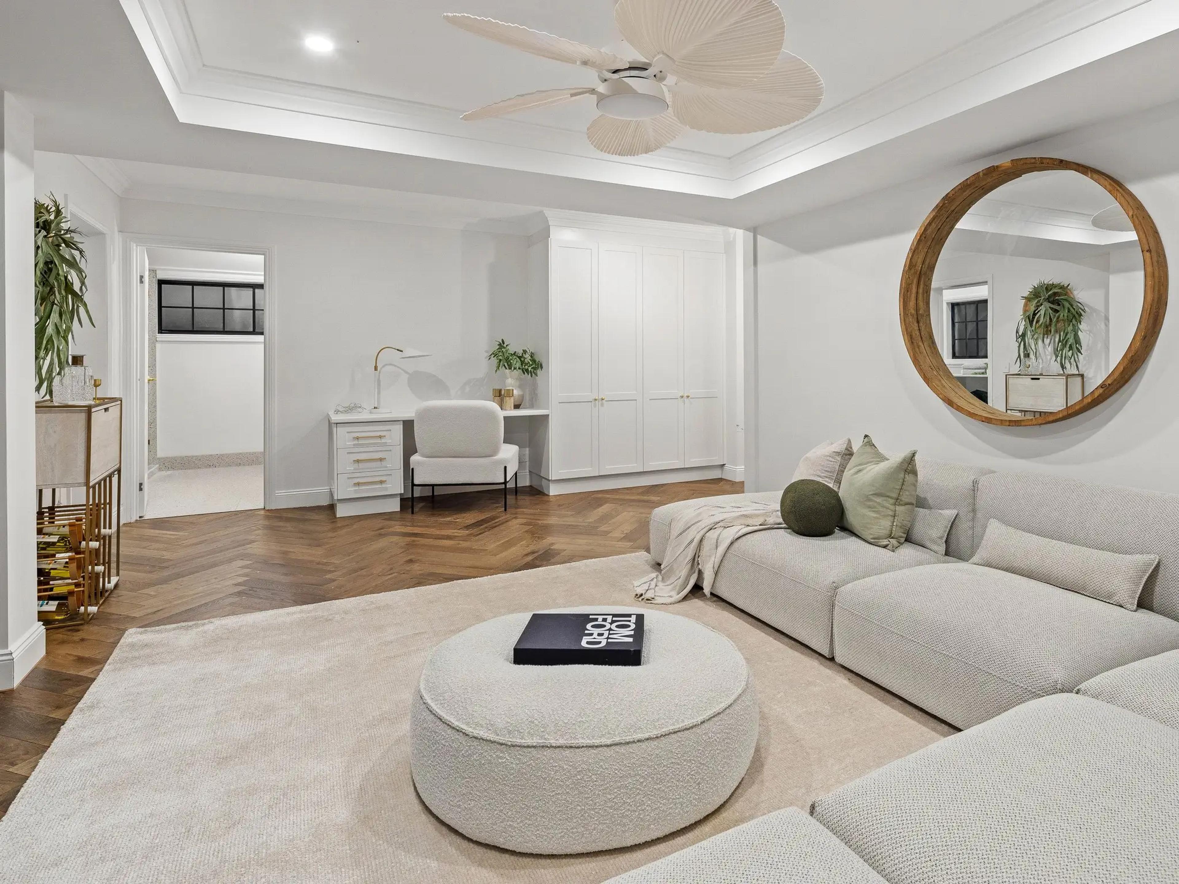 Lounge room with modular sofa and round mirror