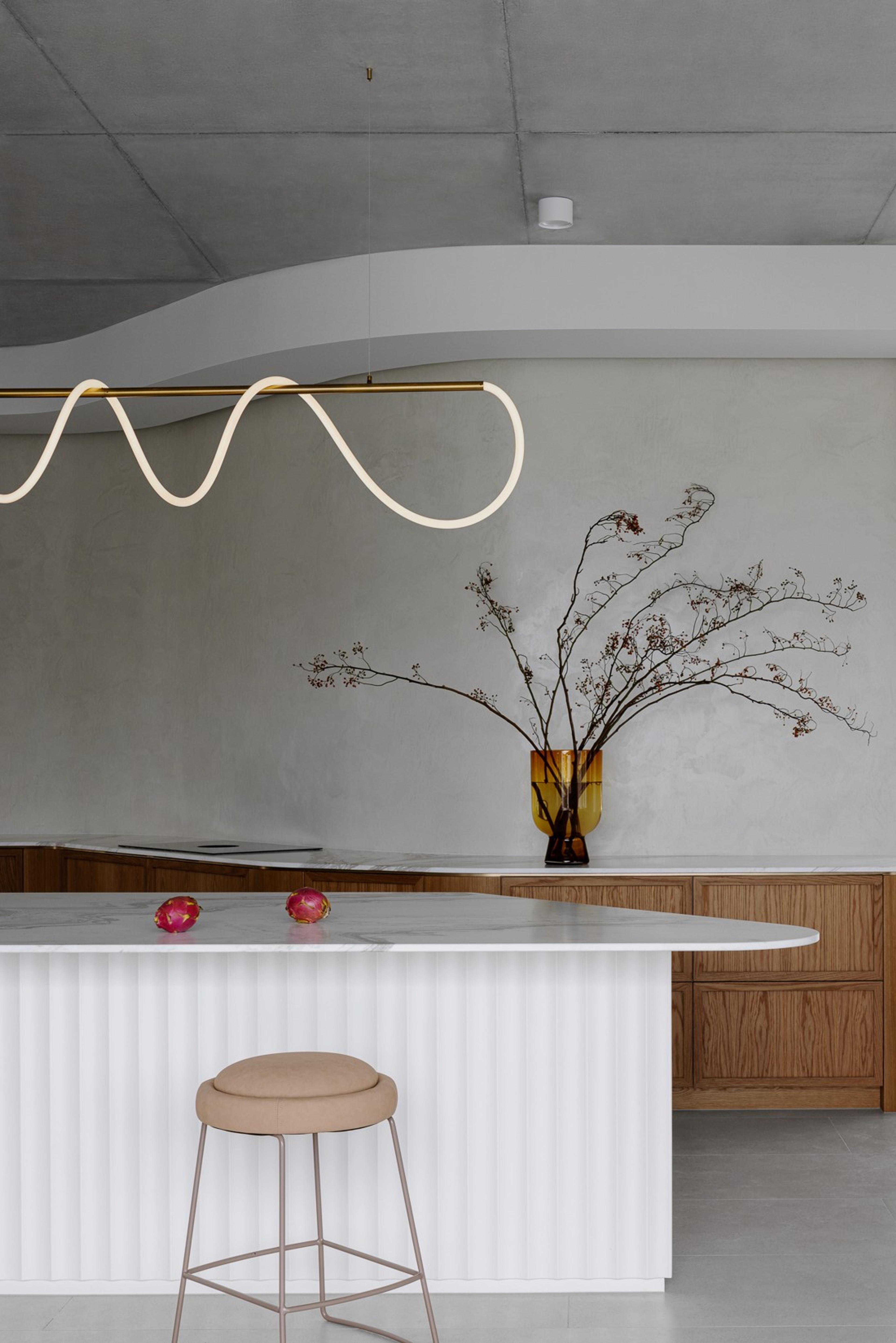 Kitchen island against textured wall with dried floral vase