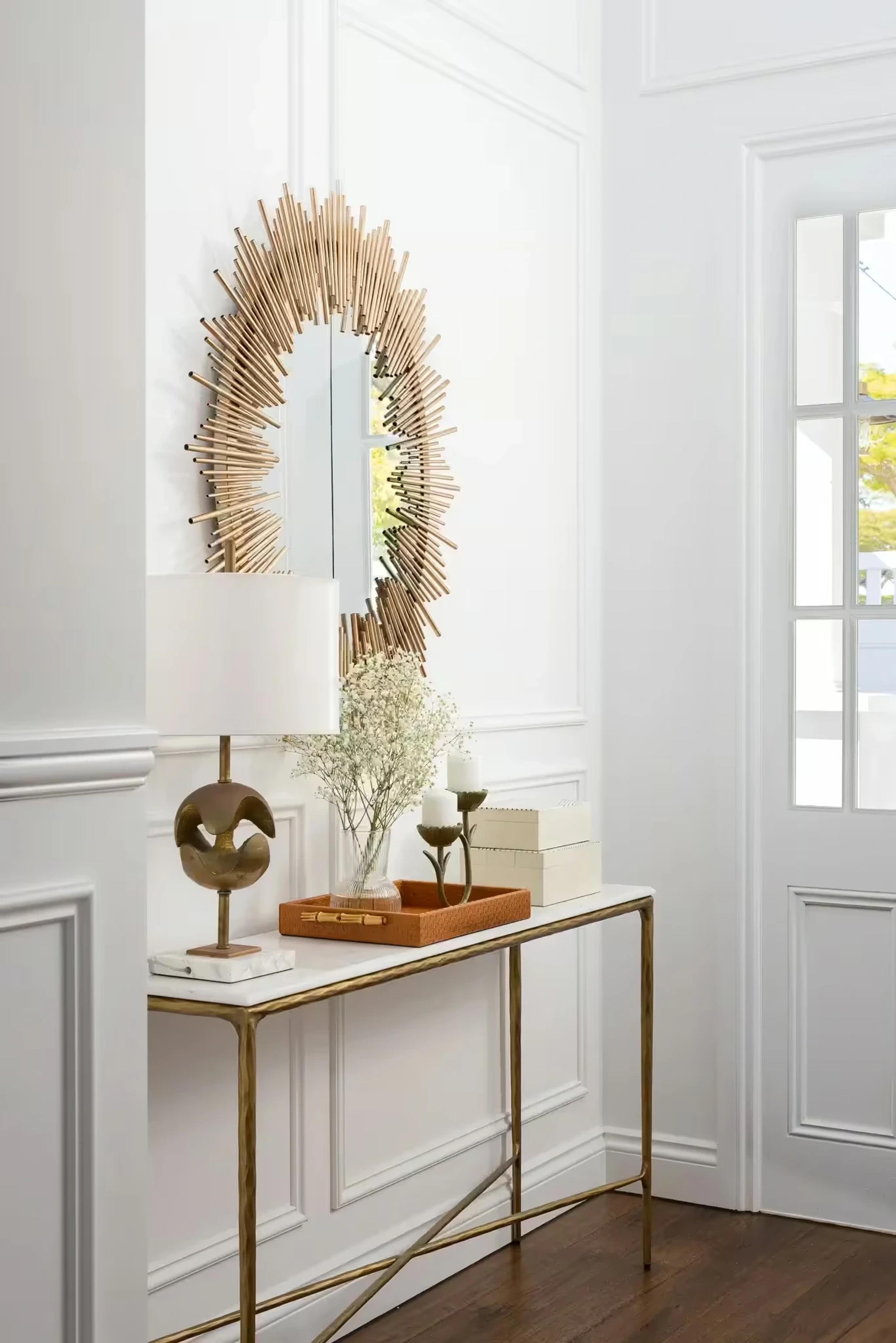 Entry console table with gold sunburst mirror and lamp