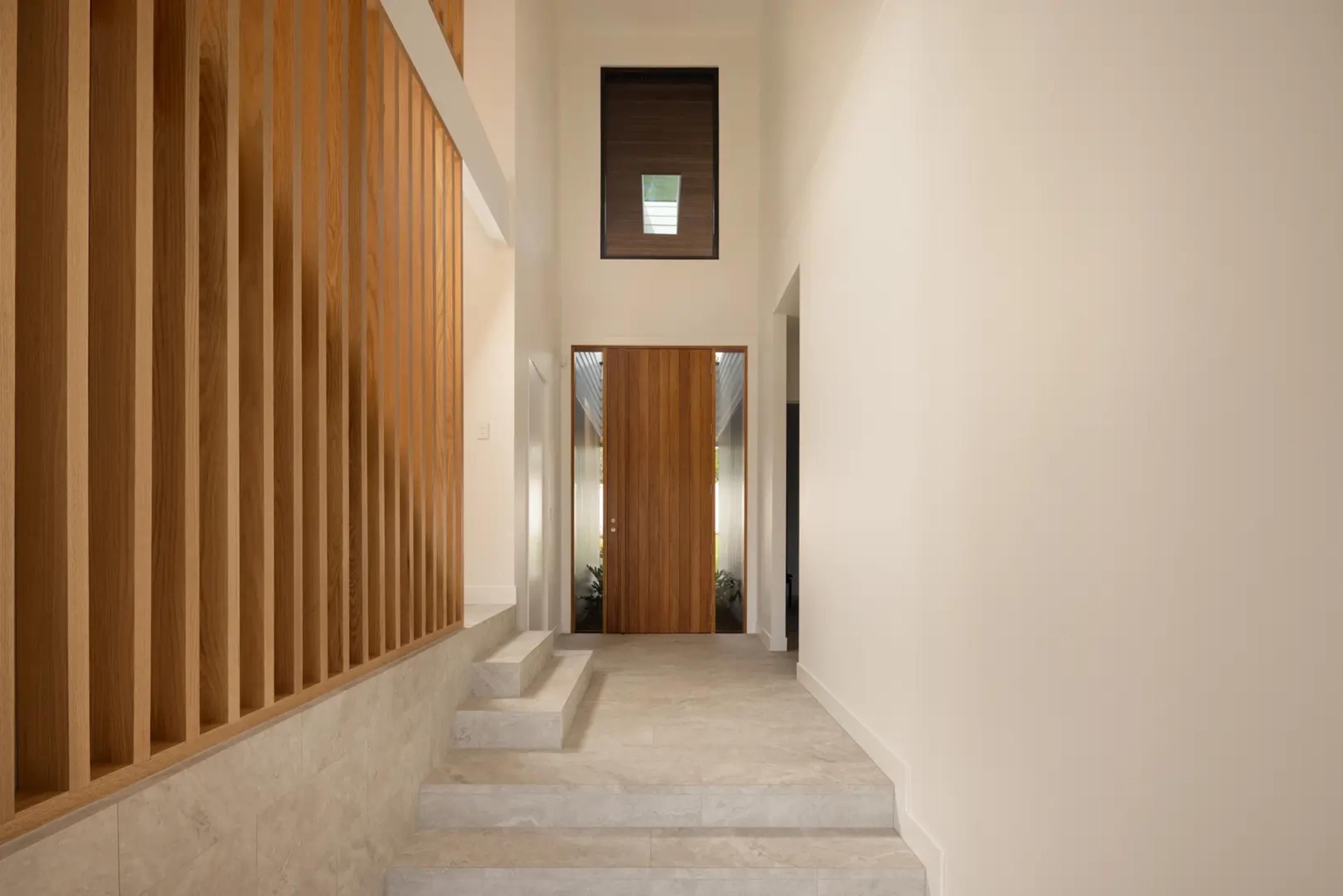 Entry hallway with timber front door and slatted screen