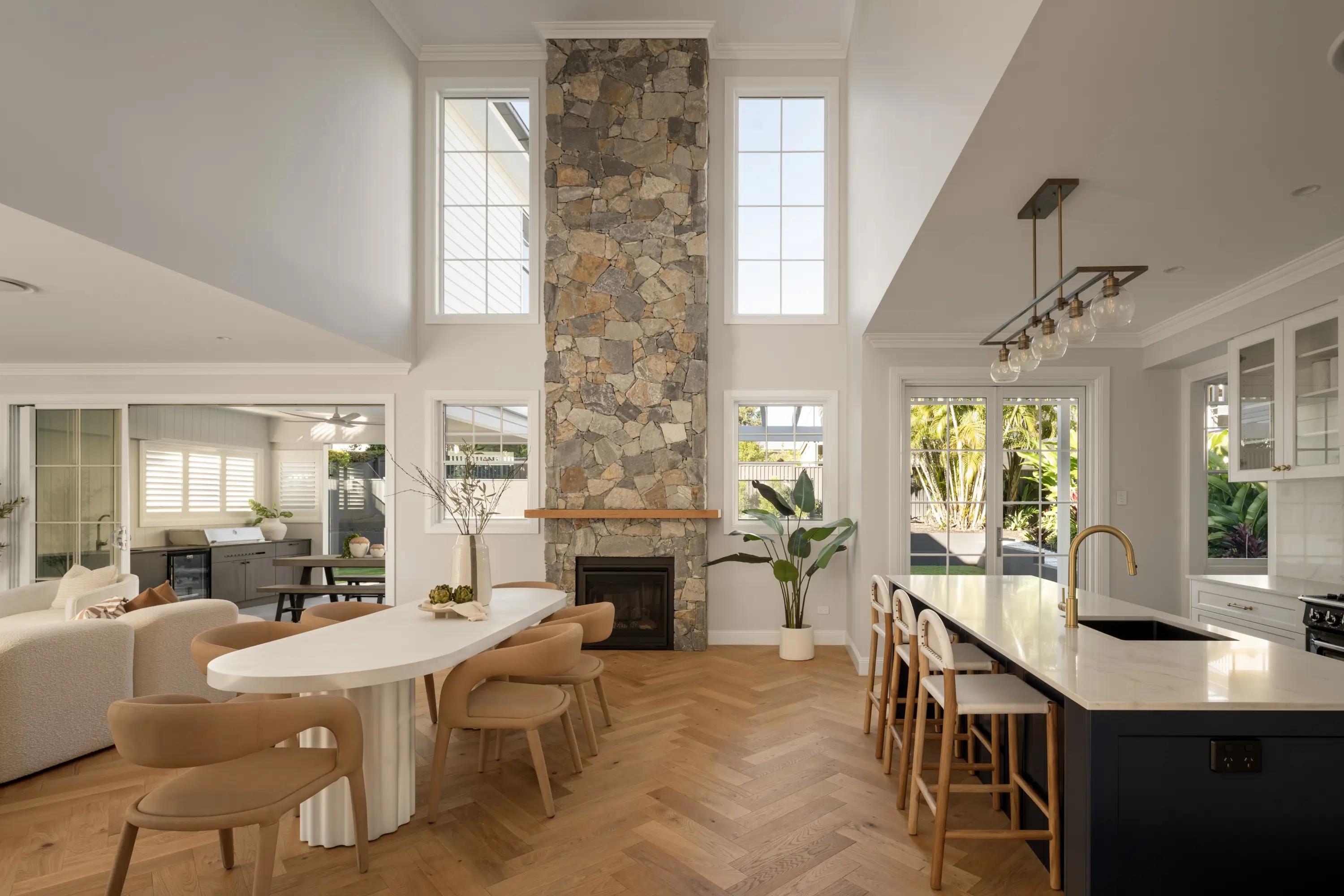 Interior of main living spaces in a narrow block home design filled with natural light 