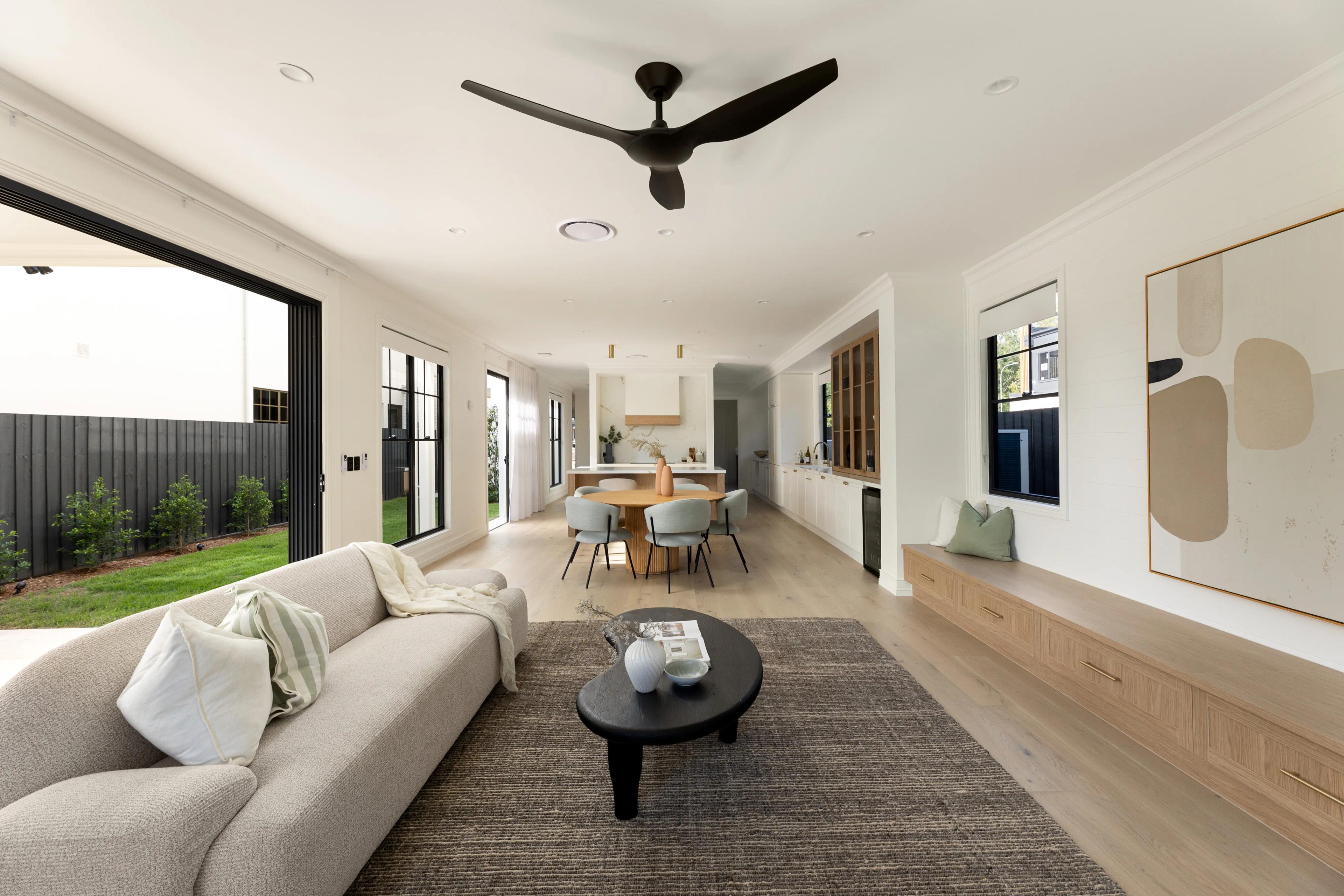 Open plan living and kitchen area demonstrating cohesive, timeless interior design in a modern Australian home.