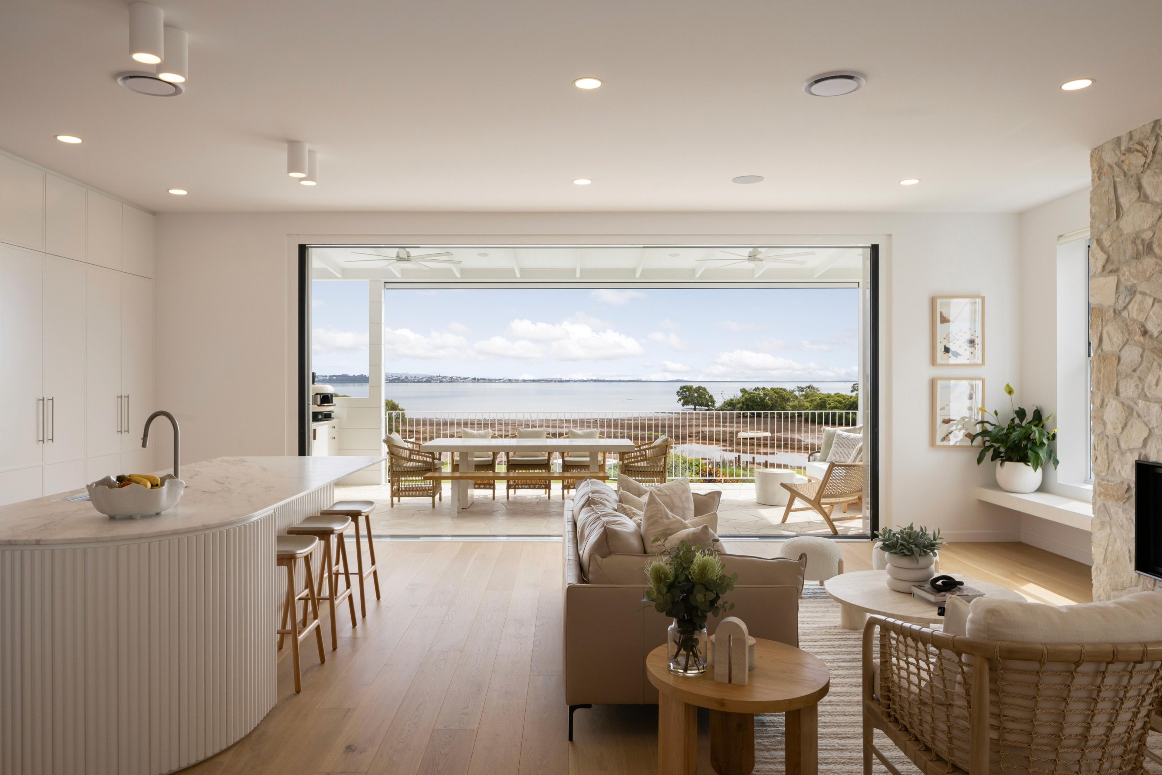 Kitchen and living area opening to water views