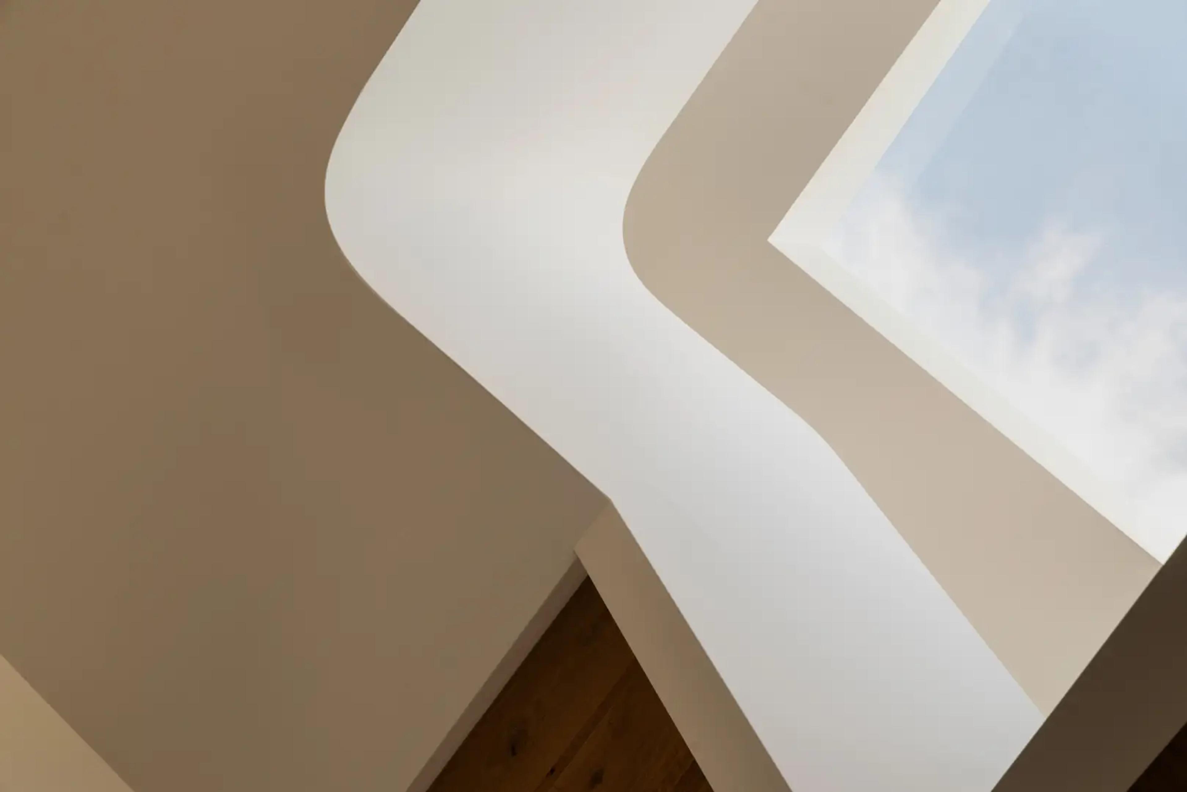 Curved stair void detail beneath a skylight