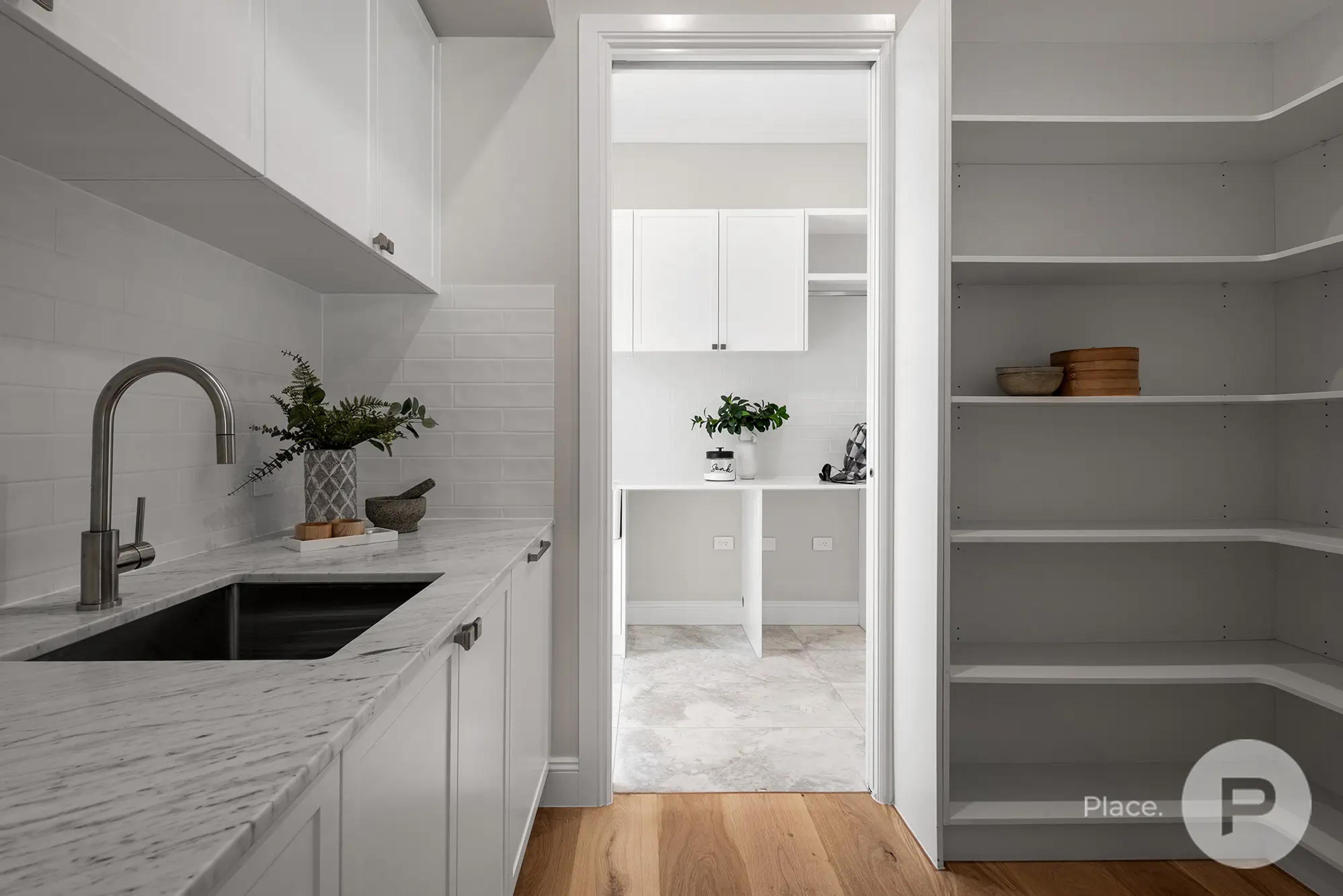 Butler's pantry with sink and open shelving