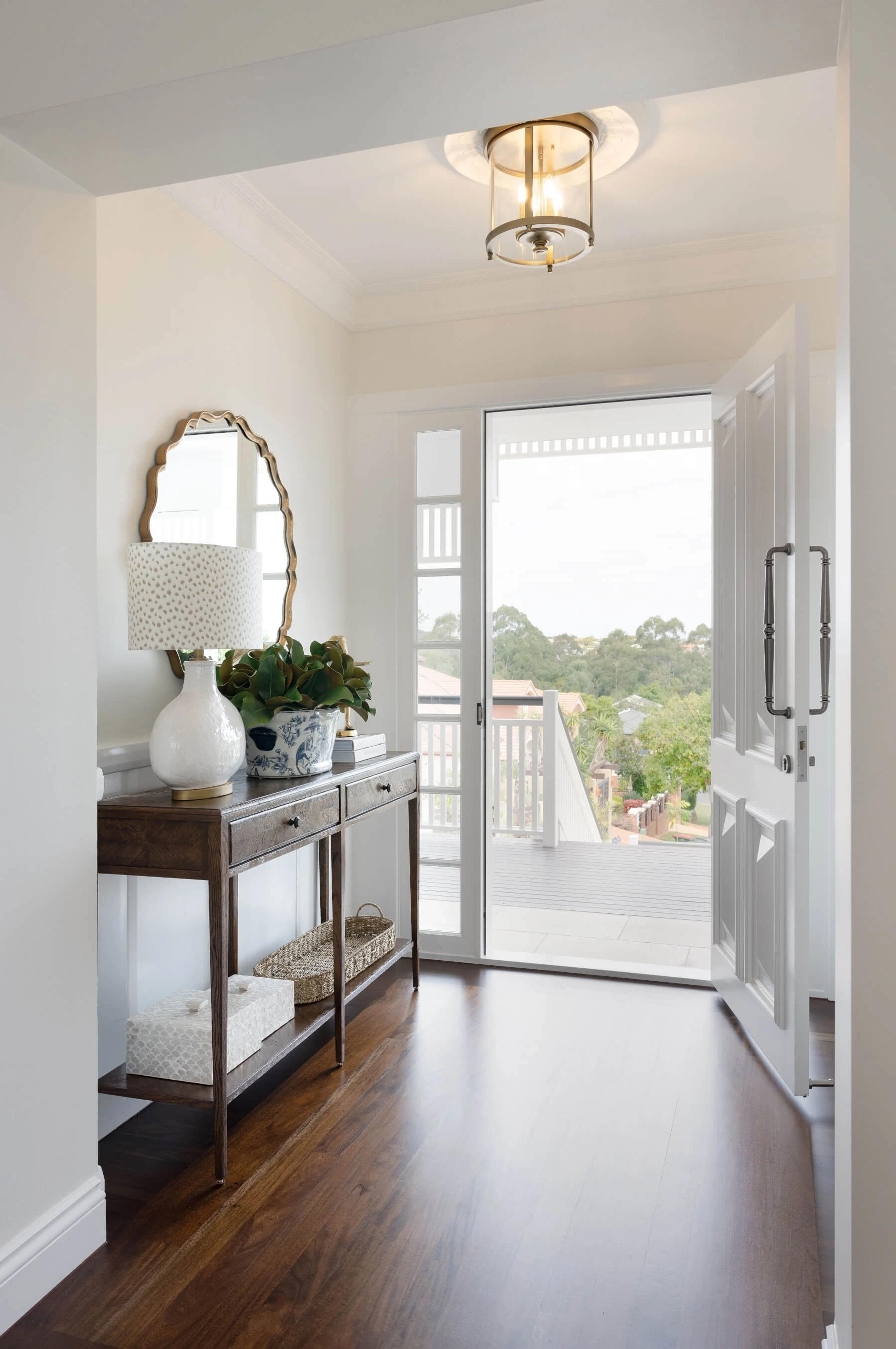 Entry foyer with console table and open front door