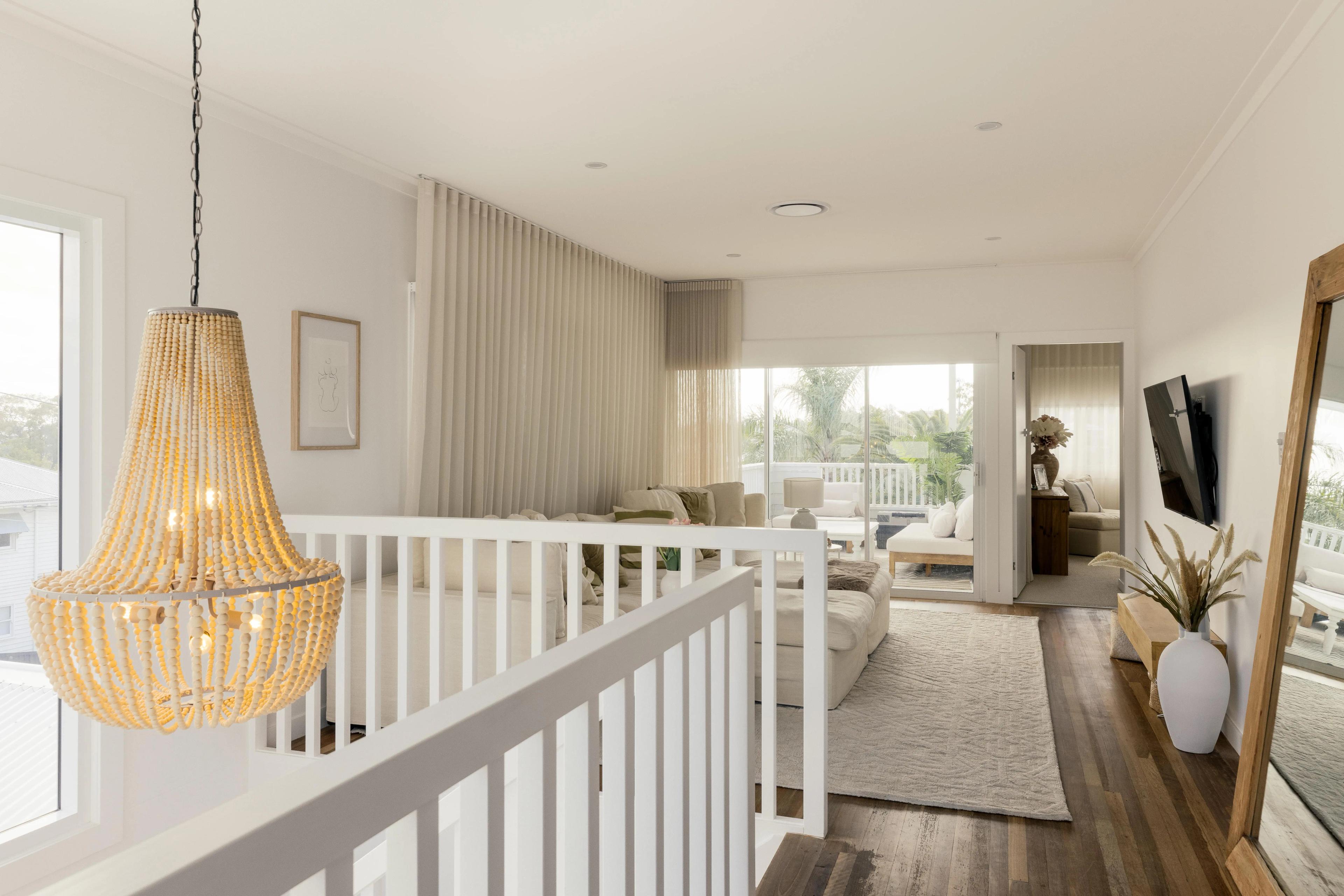 Upstairs living room with beaded chandelier and timber floors