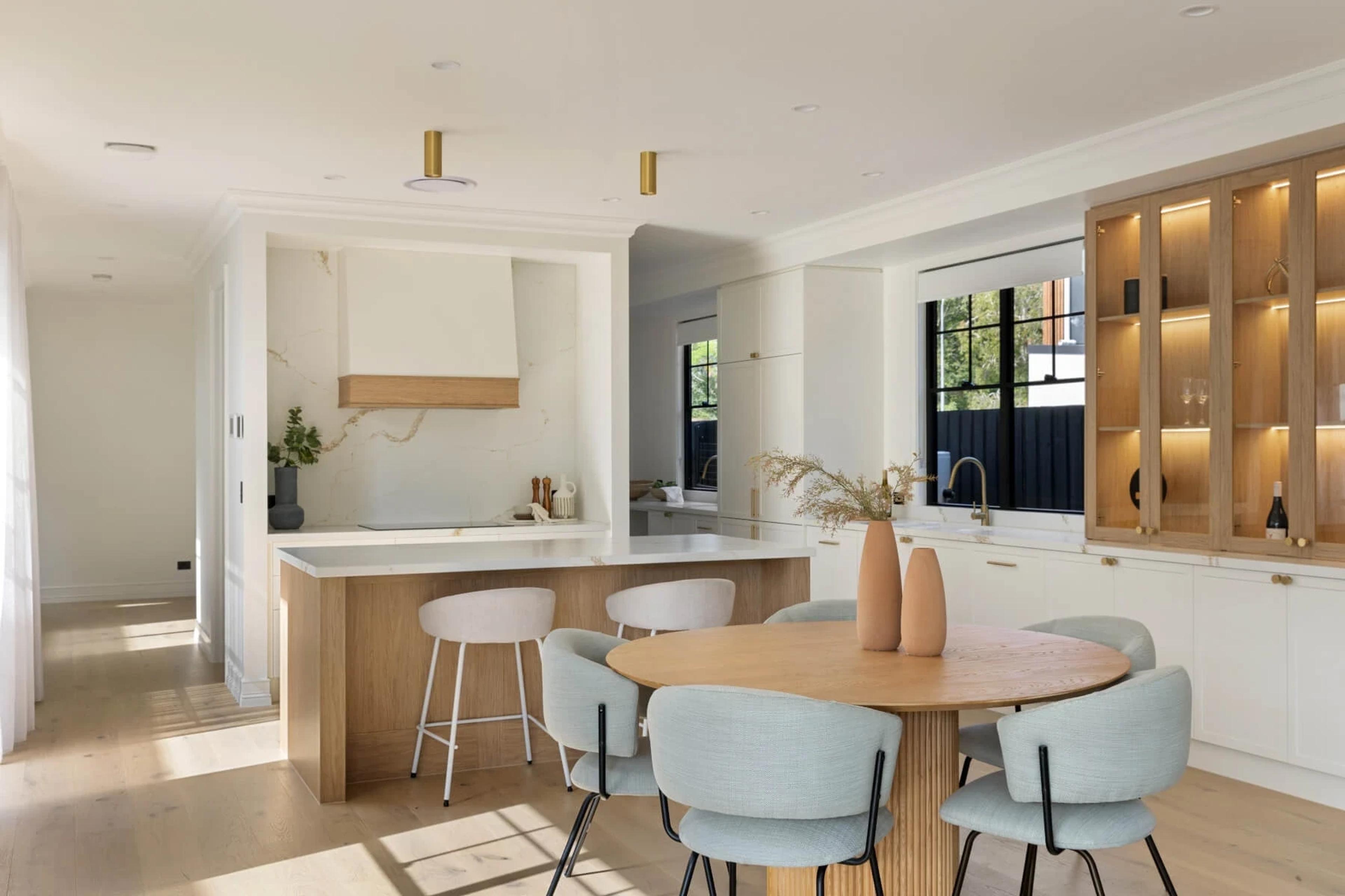 Kitchen and dining area with timber island and glass display cabinets