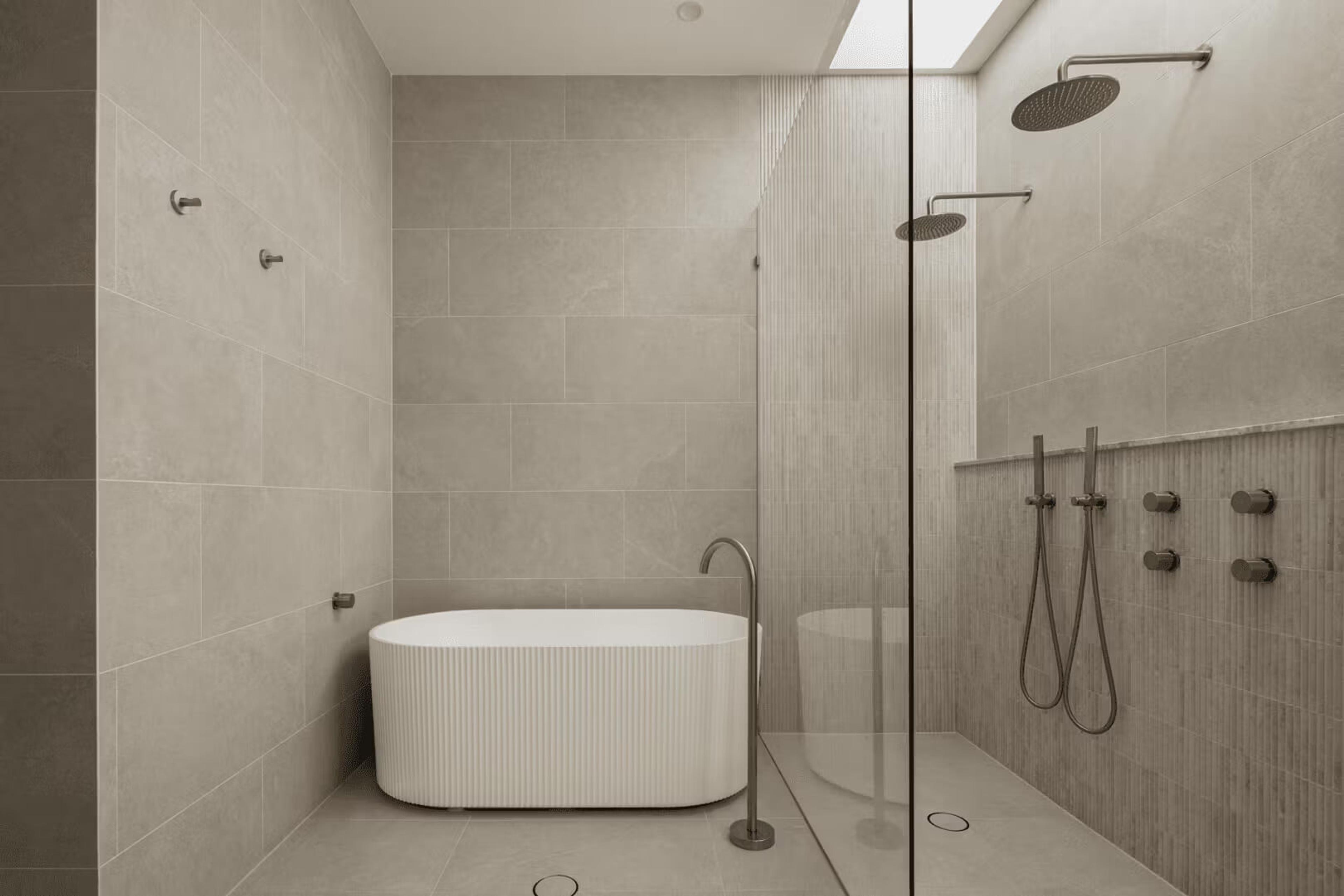 Skylight washing natural light over a double shower and freestanding bath at Aydin, a custom home by Invilla Architecture in Bulimba