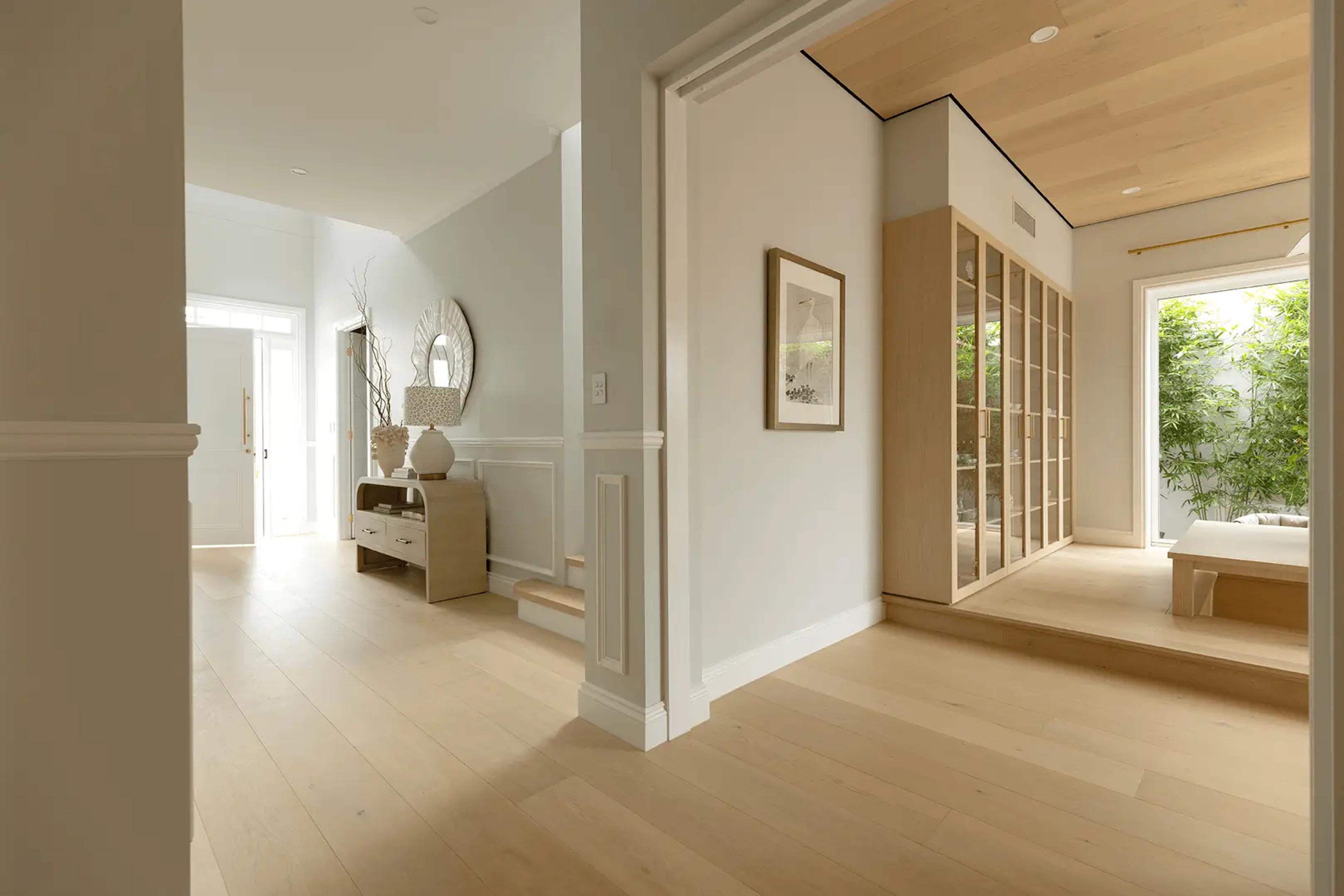 Entry hallway with console table and stair beyond