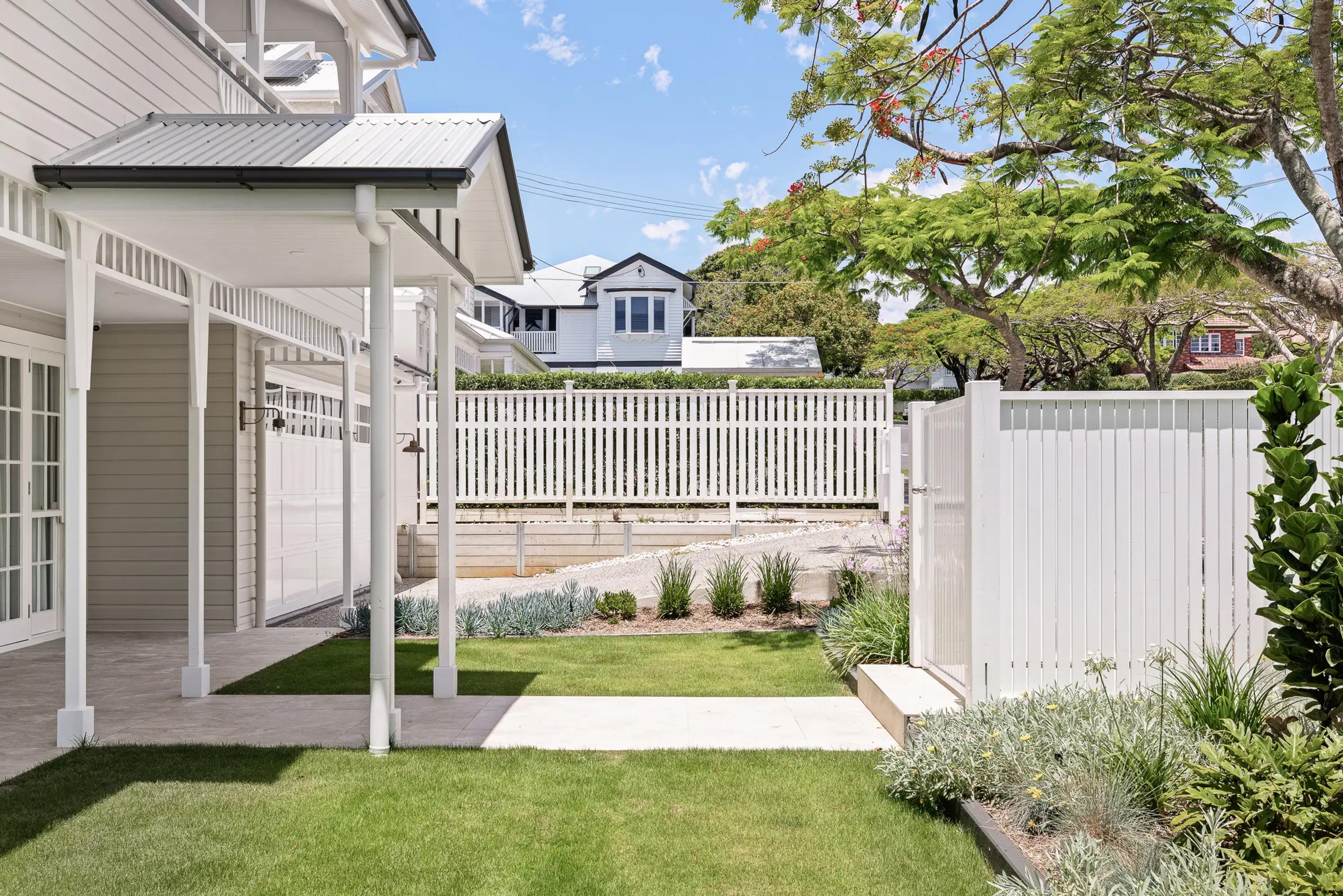 Side garden with covered walkway and landscaped lawn