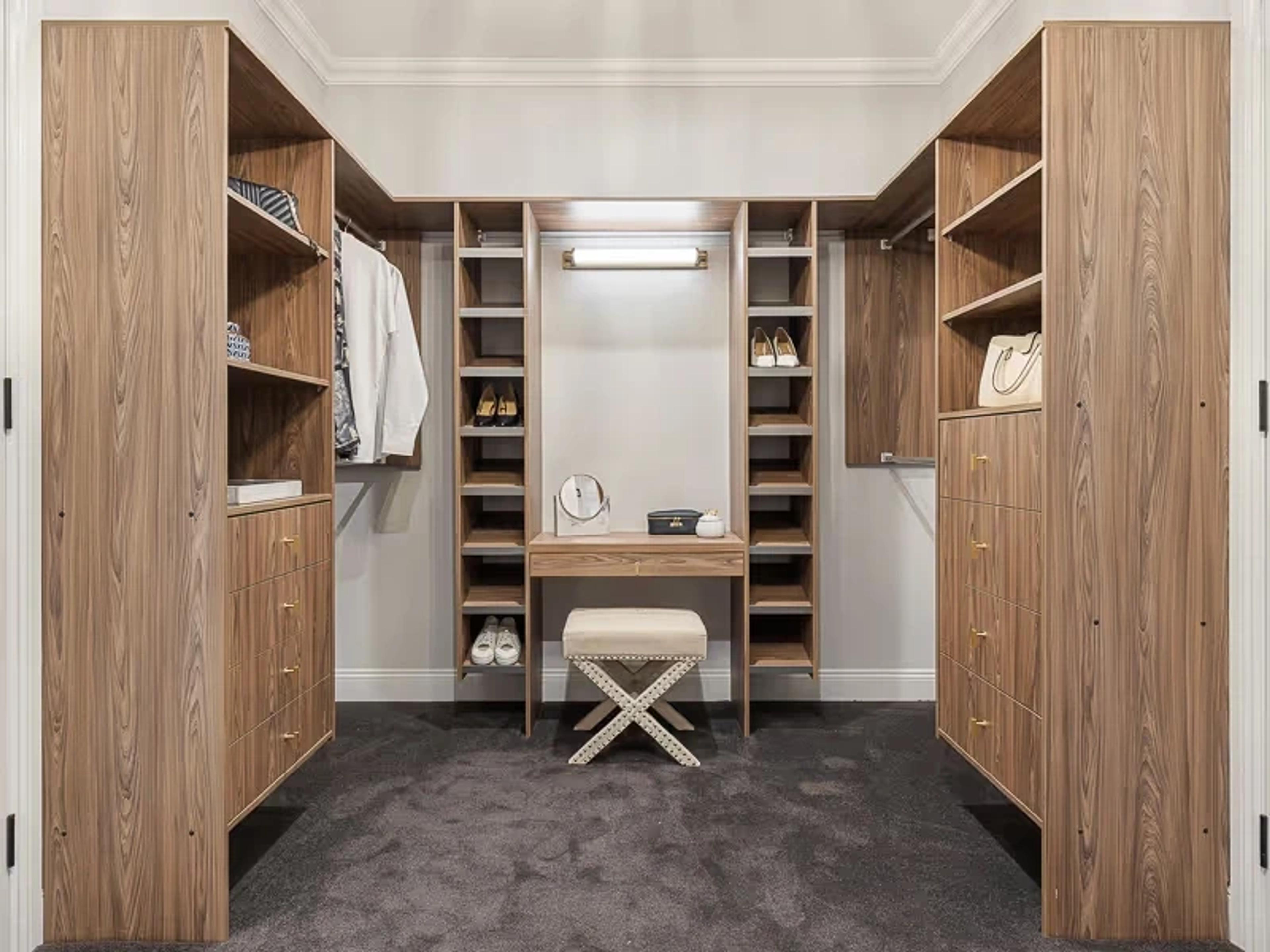 Timber walk in wardrobe with shelving and dressing stool