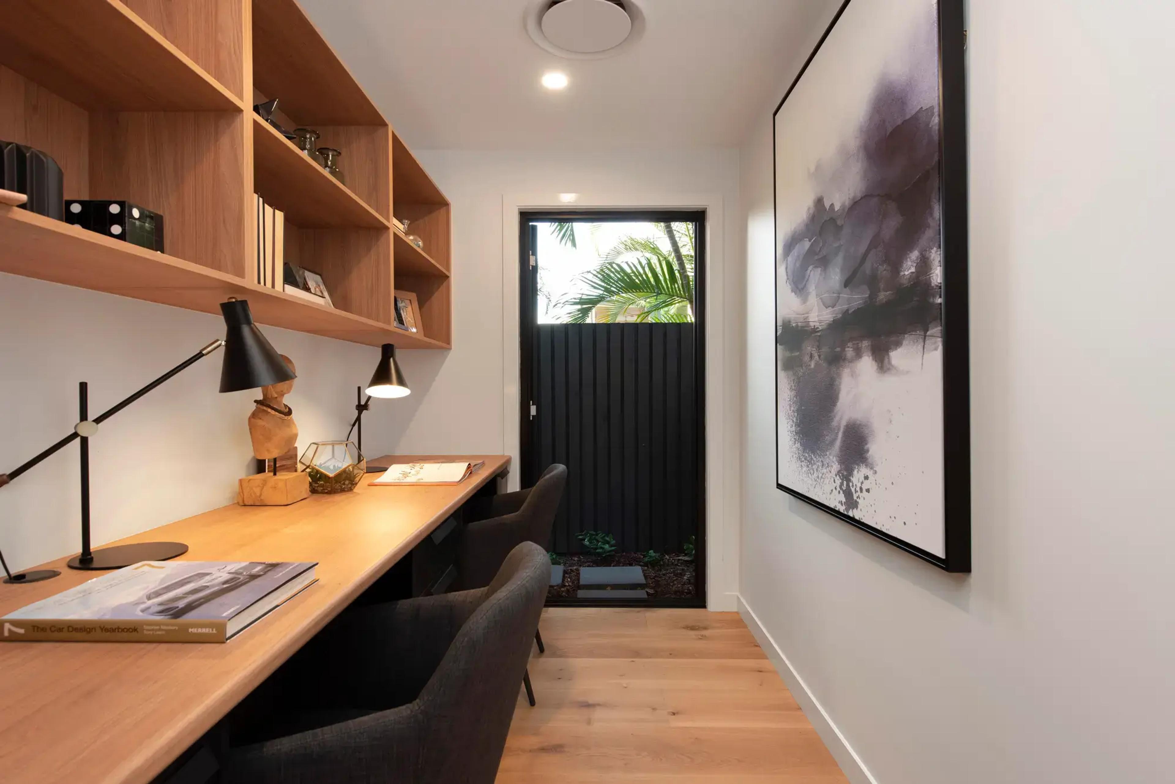 Home study with timber desk, shelving and garden door
