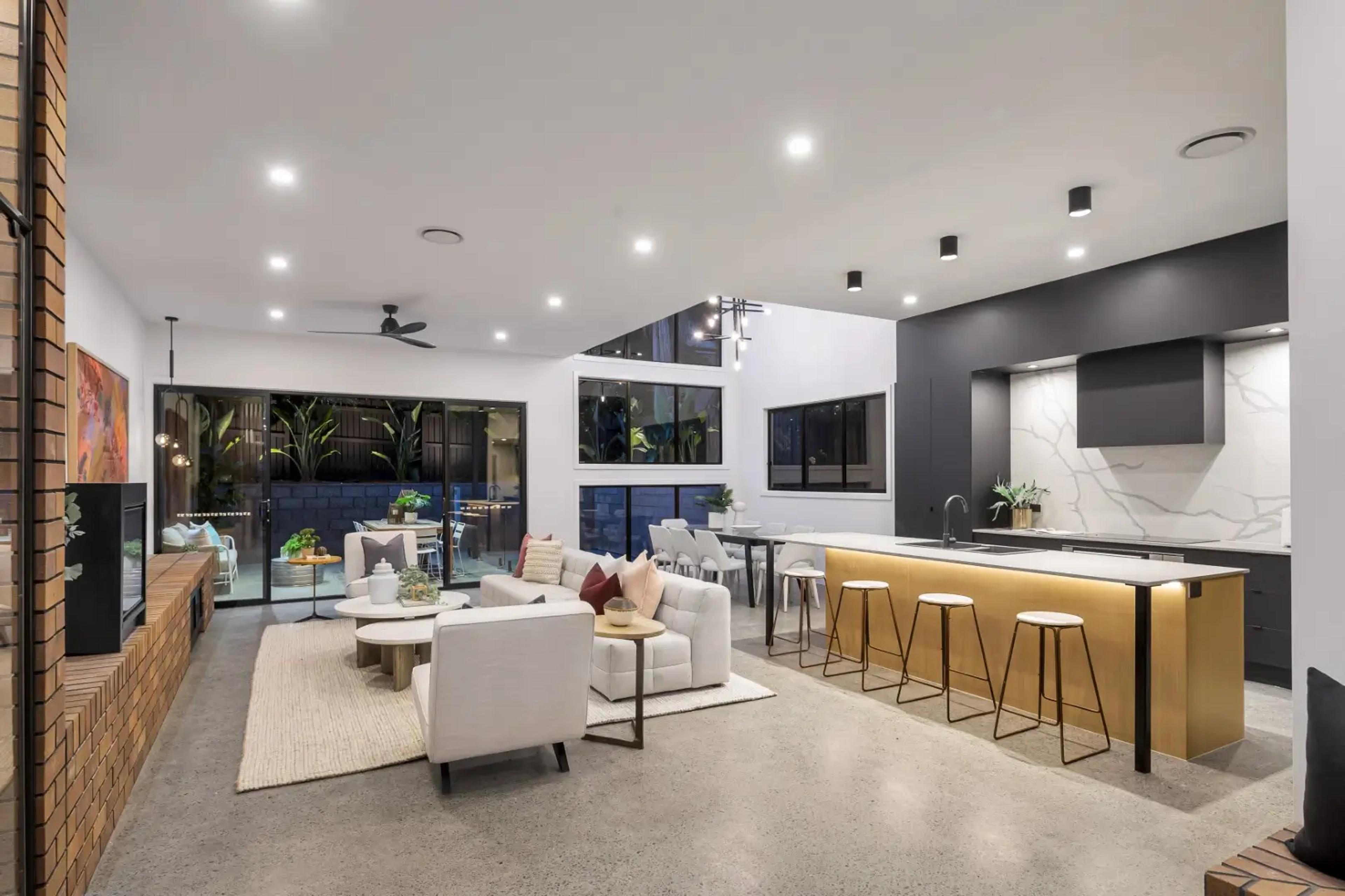Open plan living and kitchen with island and brass cabinetry
