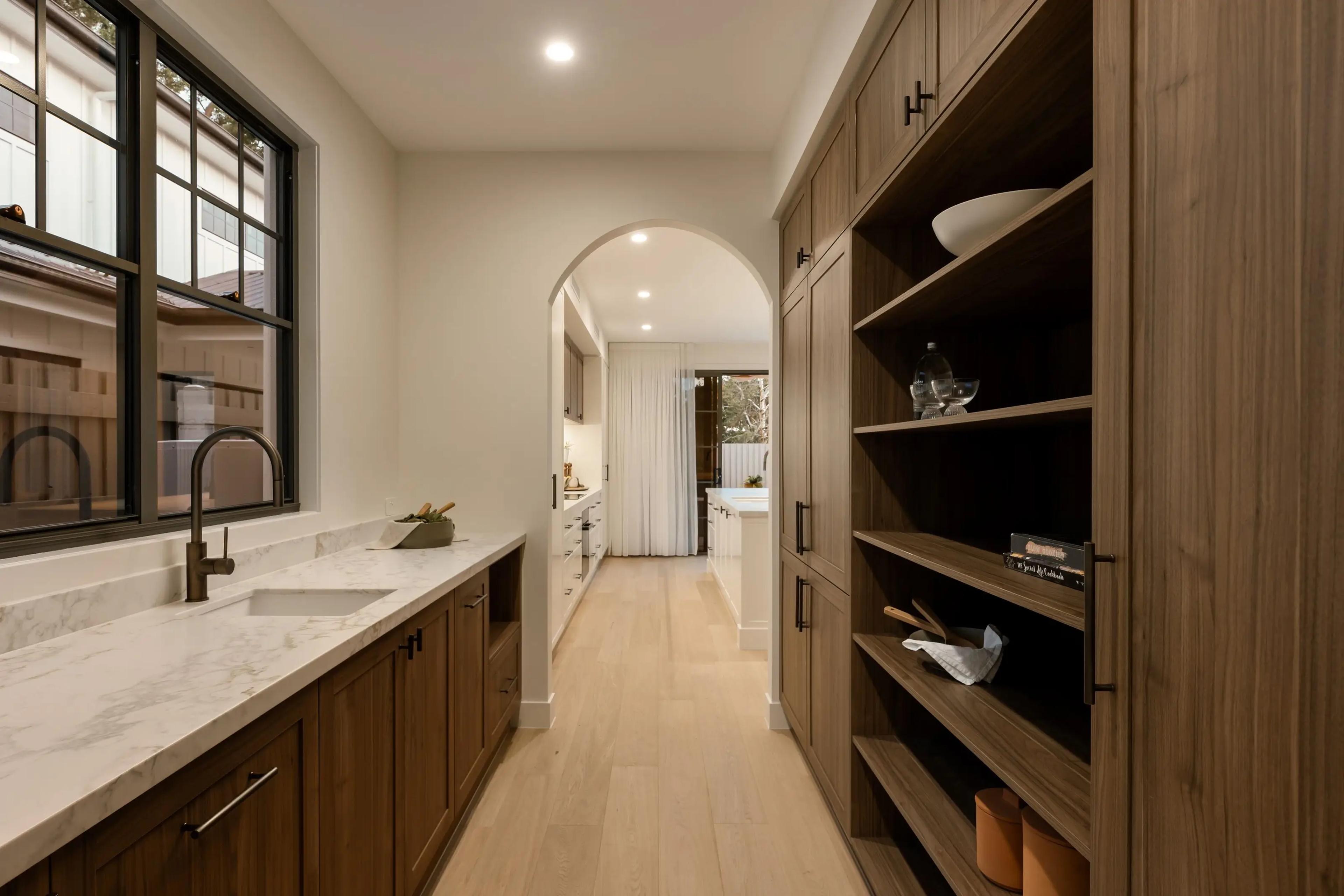 Custom butler's pantry showcasing timeless interior design with high-end architectural finishes and natural stone.