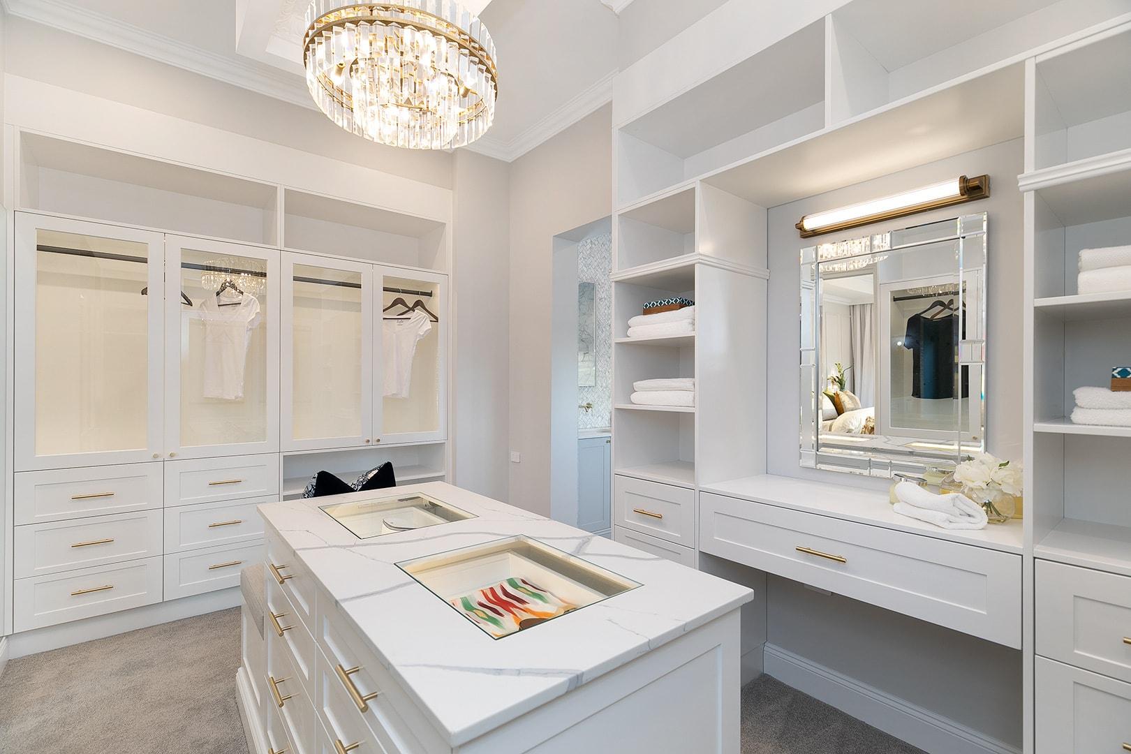 Bespoke walk-in wardrobe design featuring custom island cabinetry.