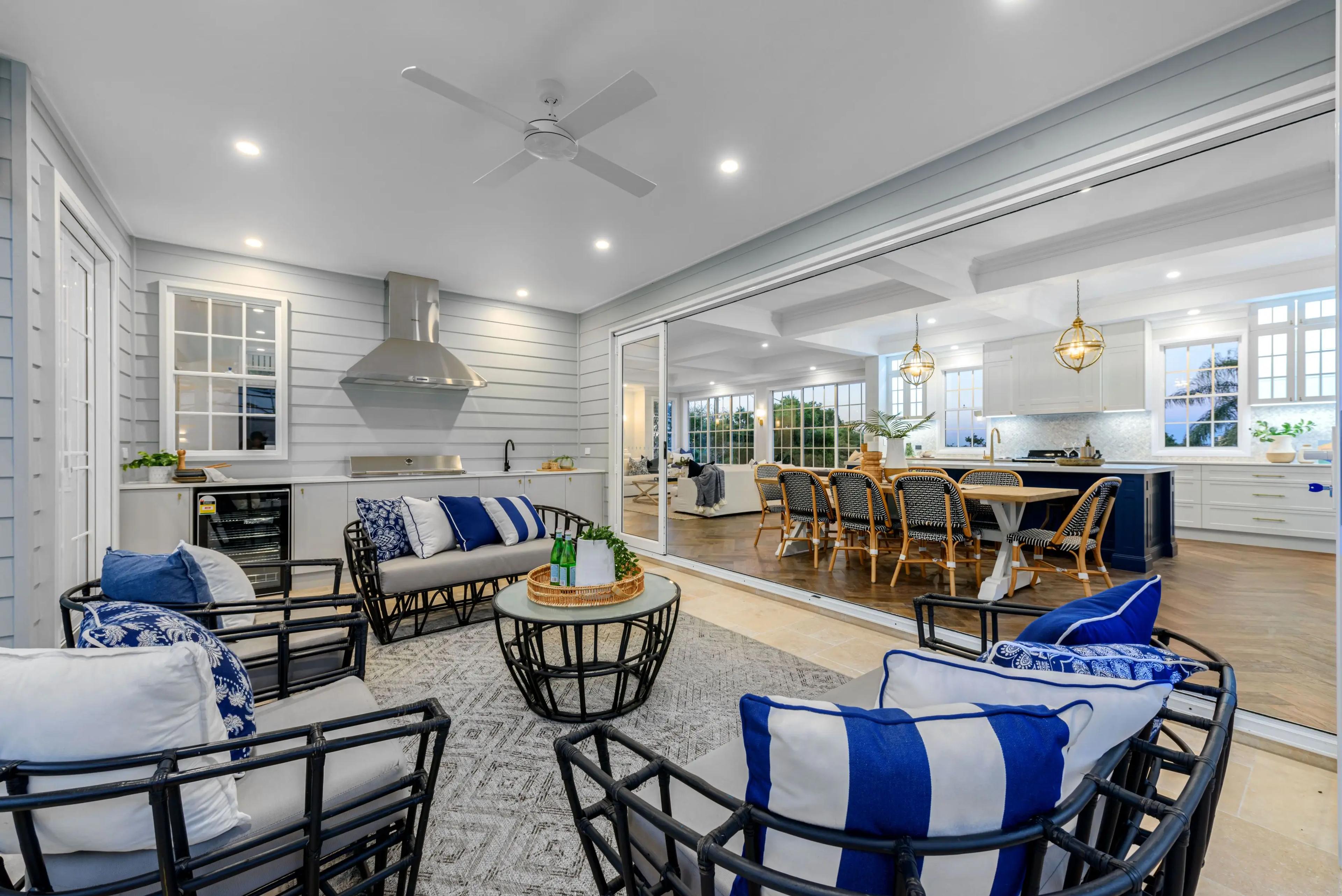 Covered outdoor lounge opening to kitchen and dining