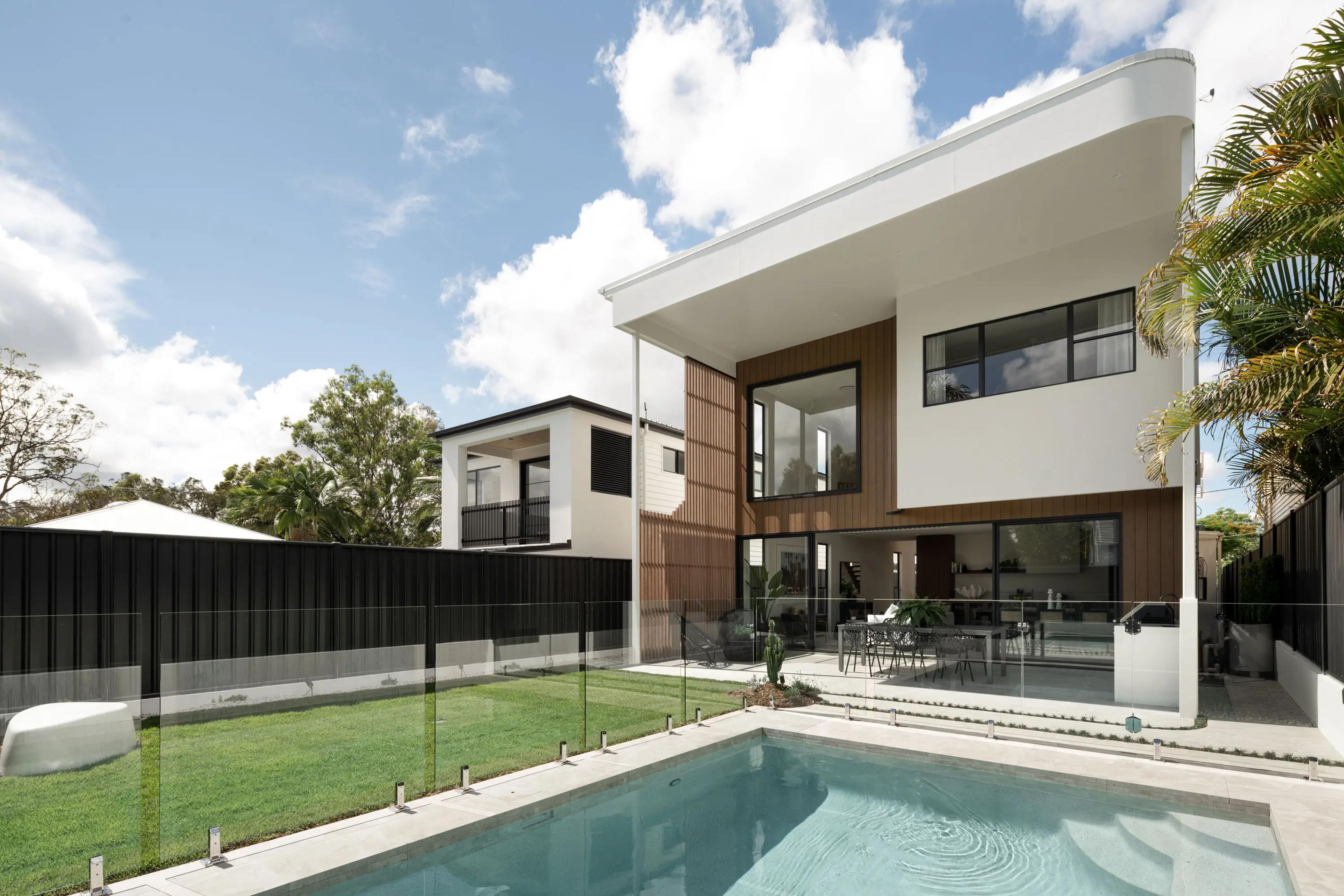 Rear elevation with pool, glass fence and lawn