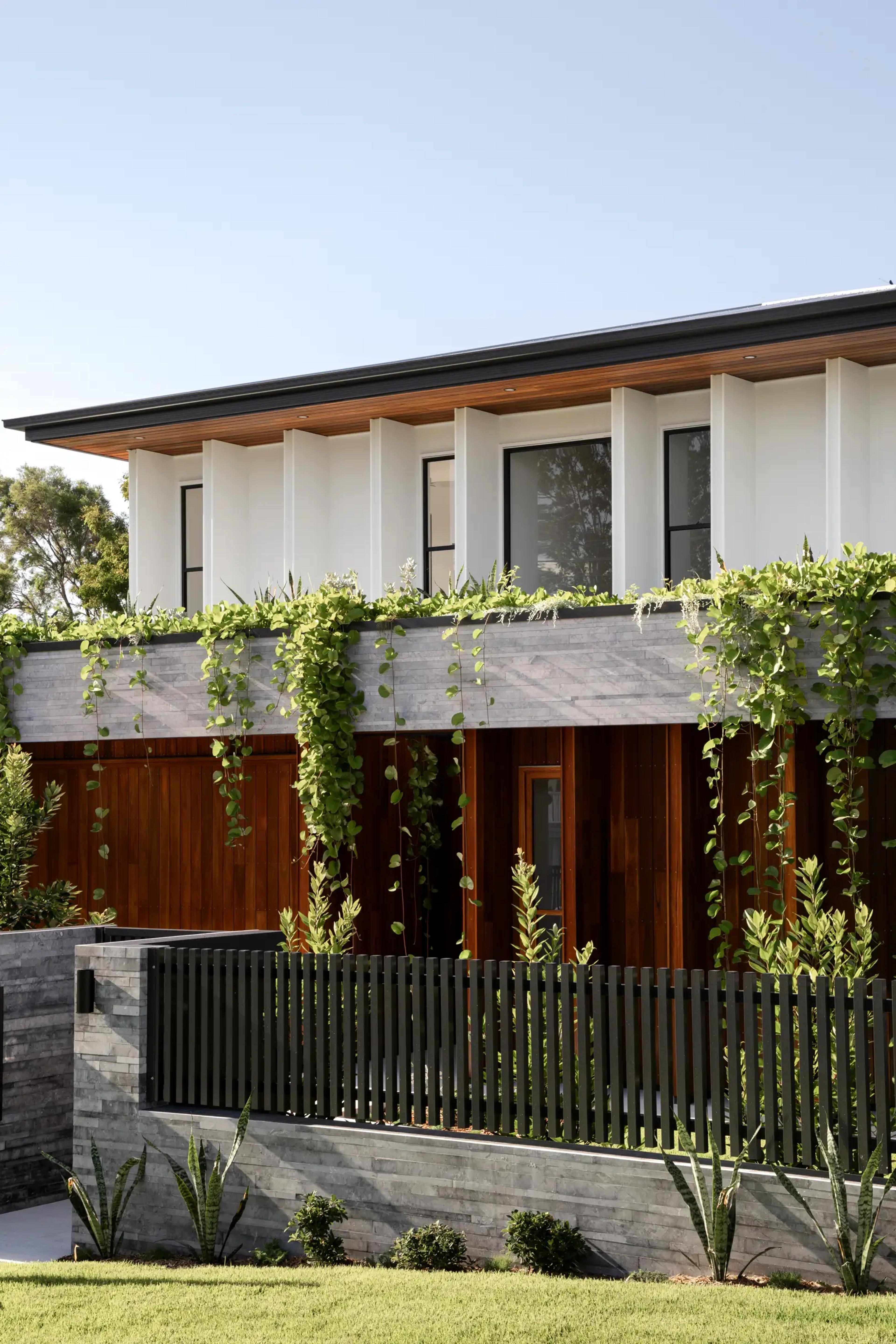 Timber and stone facade draped with cascading greenery