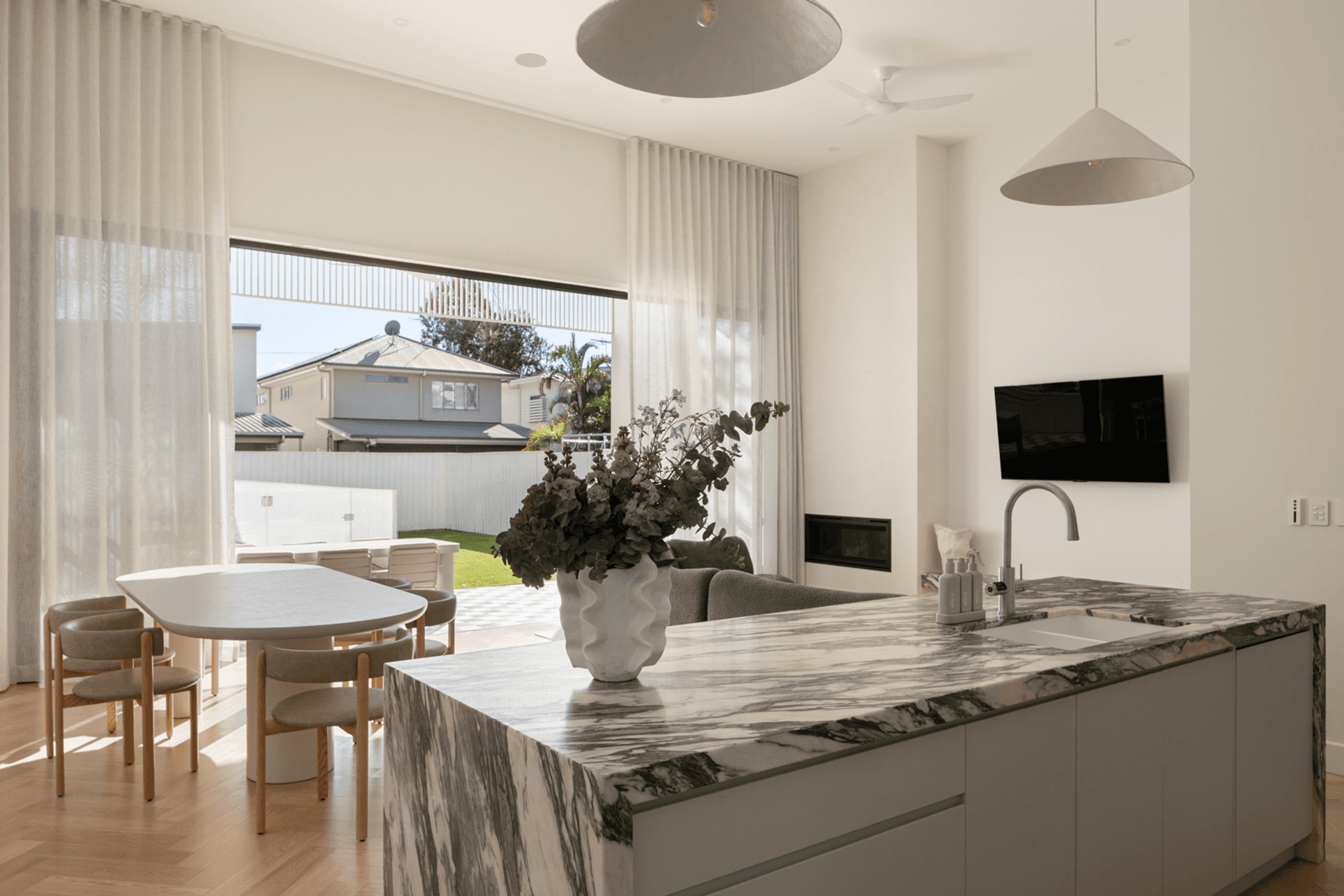 Kitchen with marble island bench and dining table