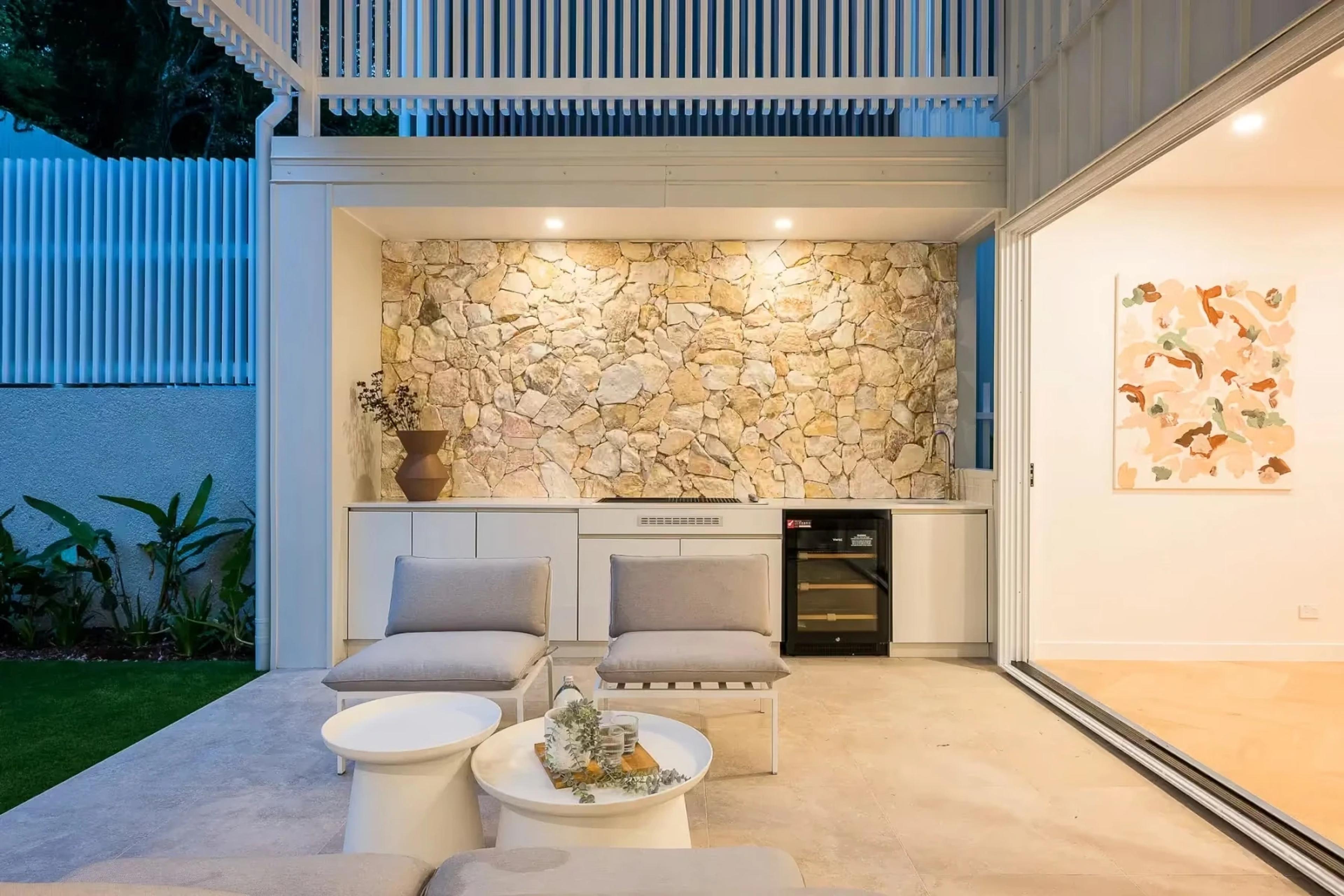 Covered outdoor lounge with stone feature wall