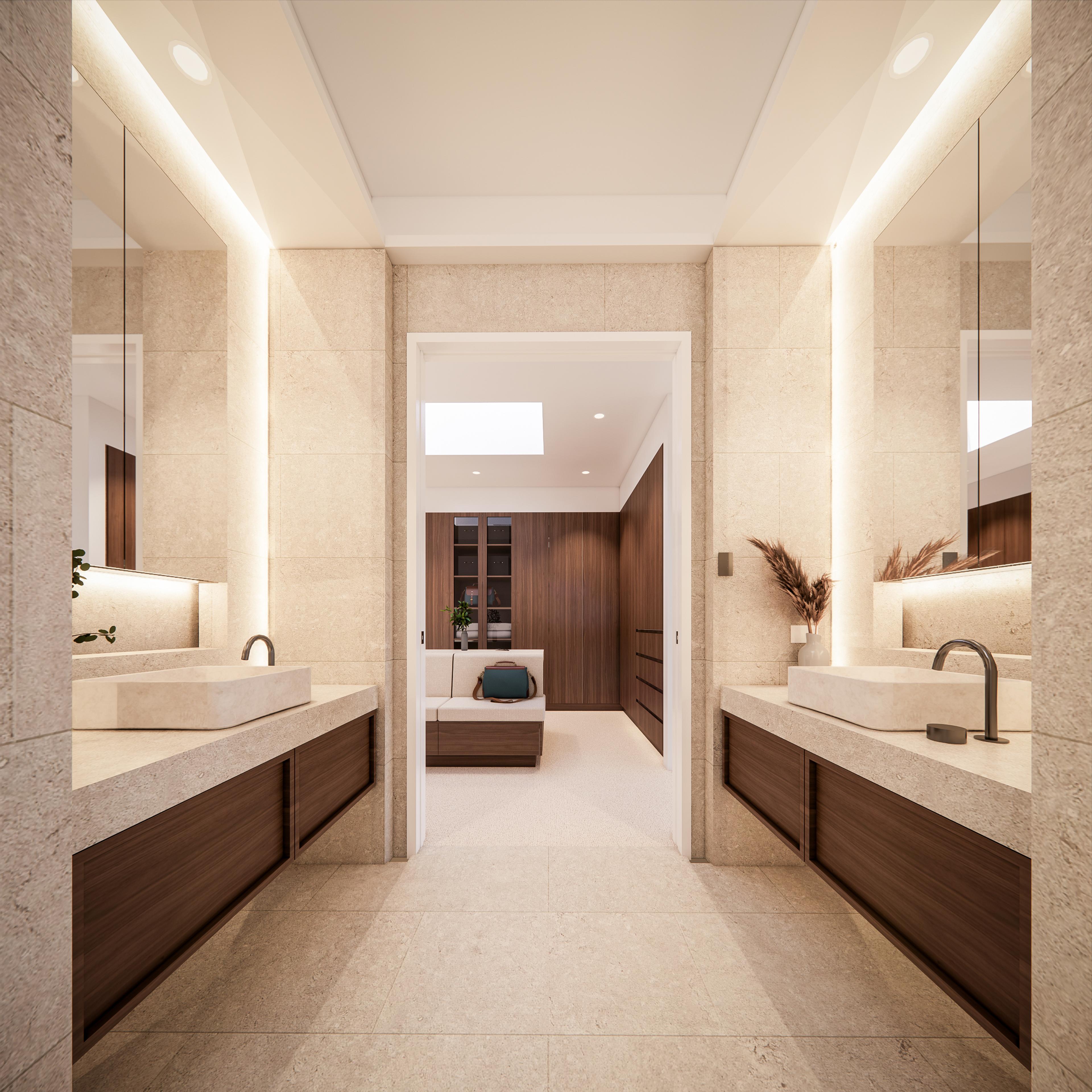 Symmetrical his-and-hers ensuite with twin stone vanities and mirrors framing a view into the wardrobe