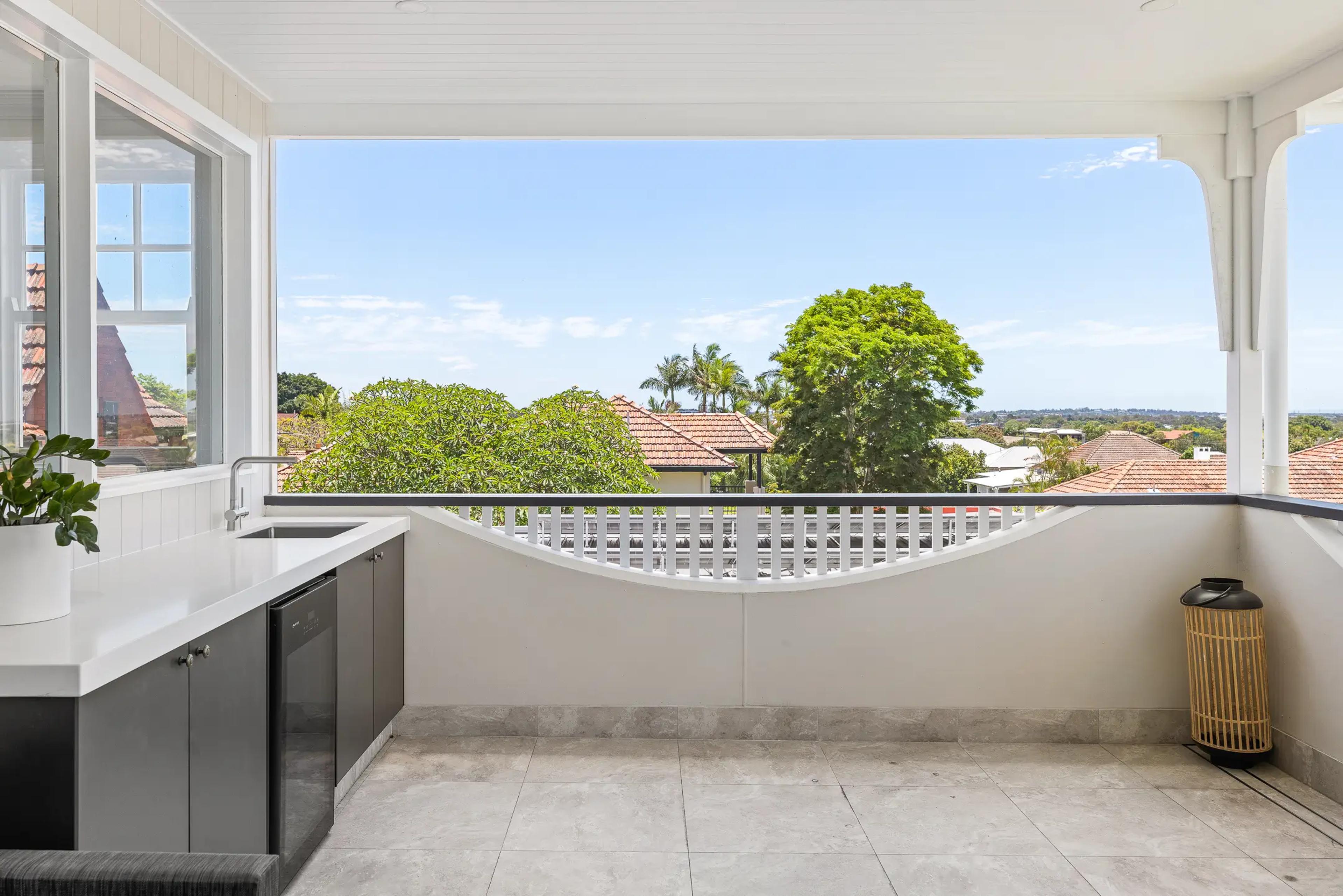 Balcony wet bar with tiled floor and rooftop views