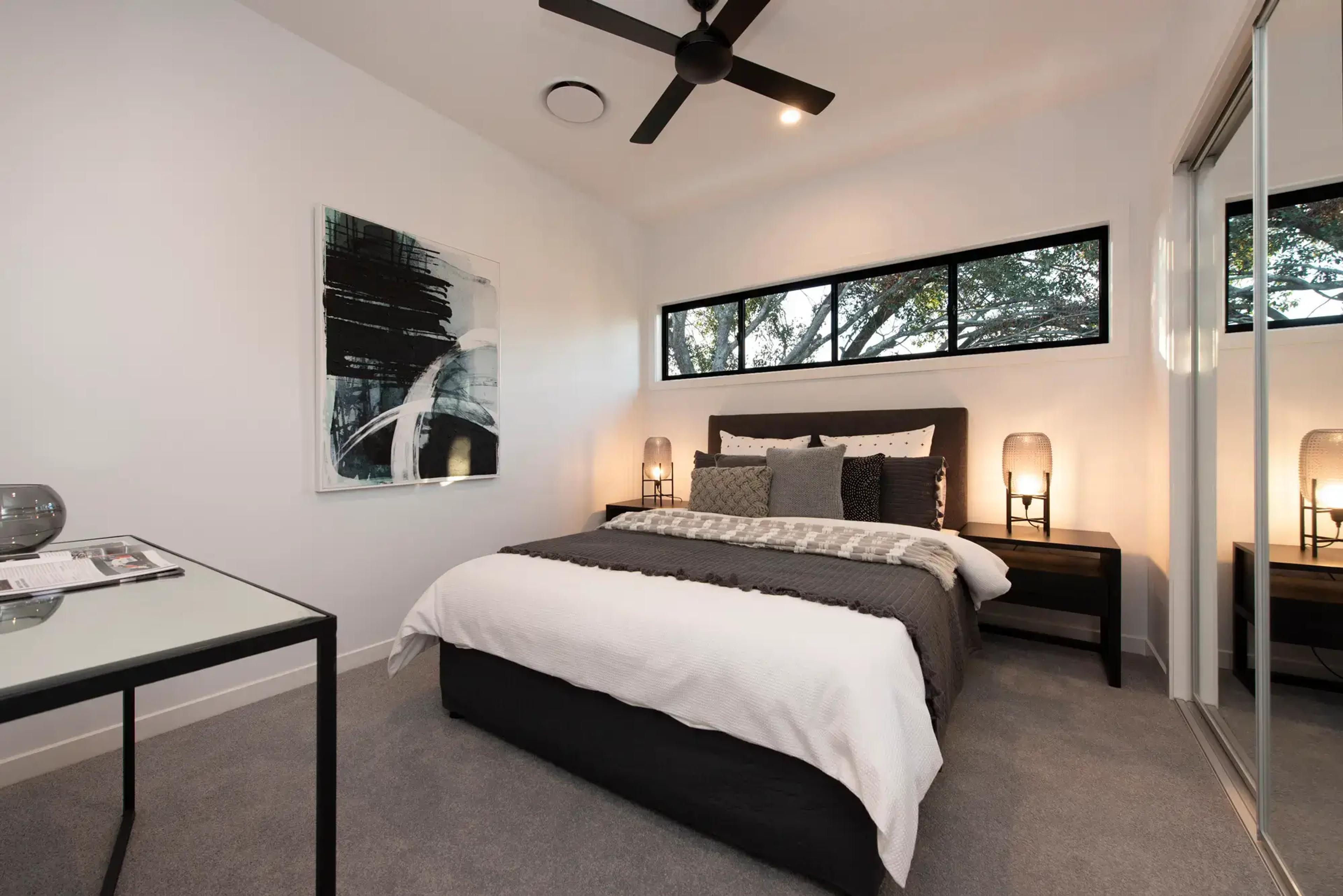 Bedroom with clerestory window and mirrored wardrobes