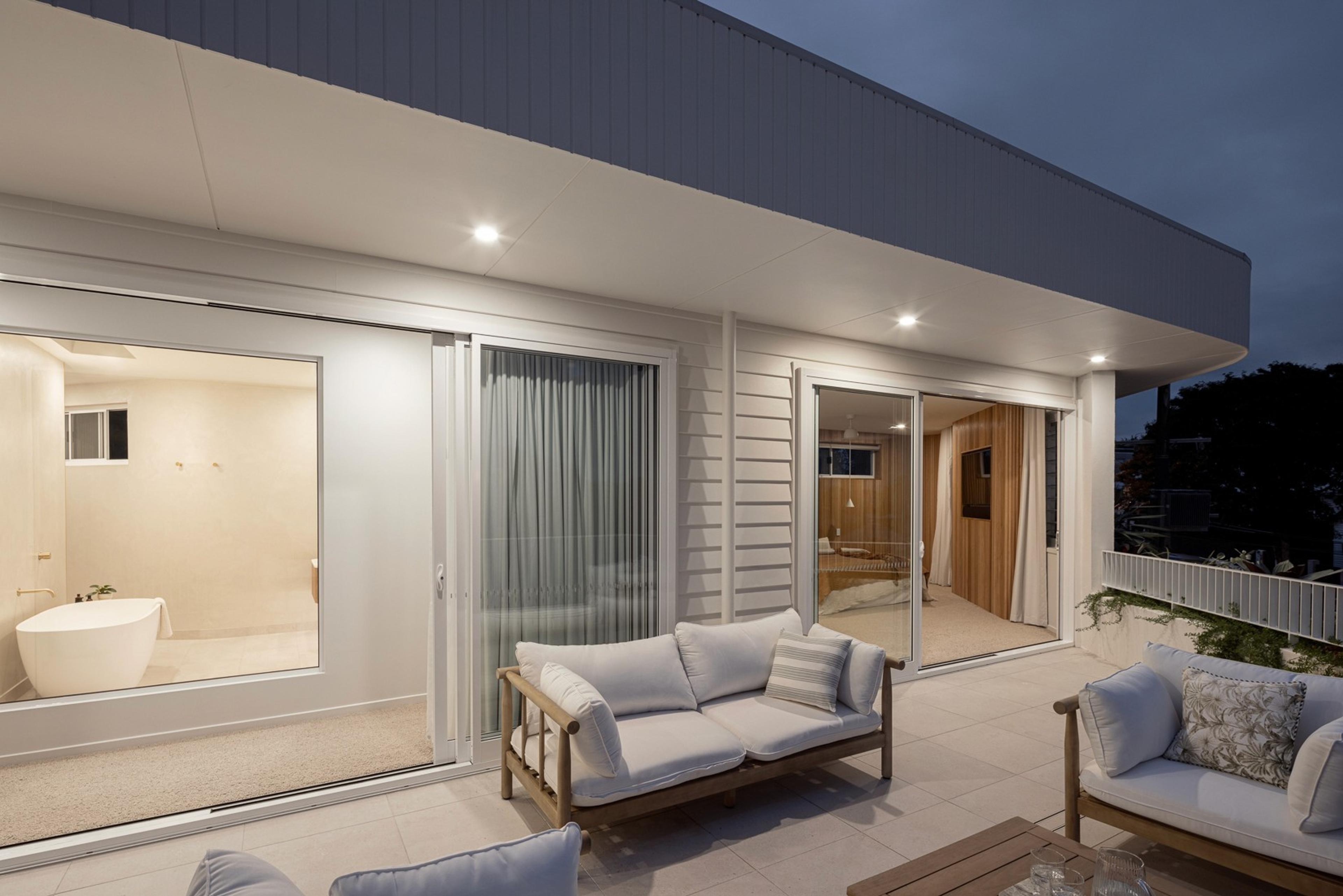 Evening terrace with lounge seating beside ensuite bathroom