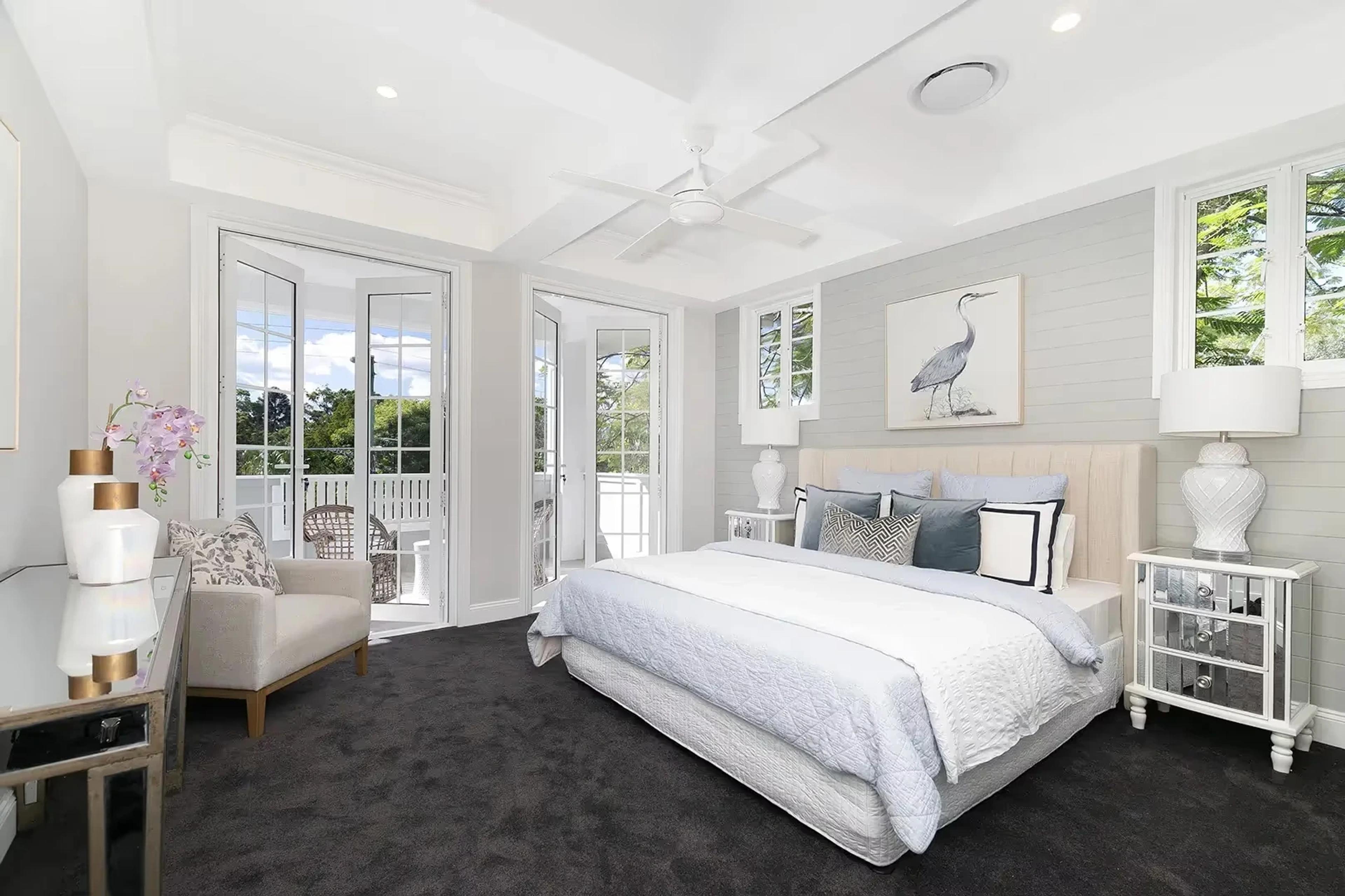 Master bedroom with French doors opening to a balcony