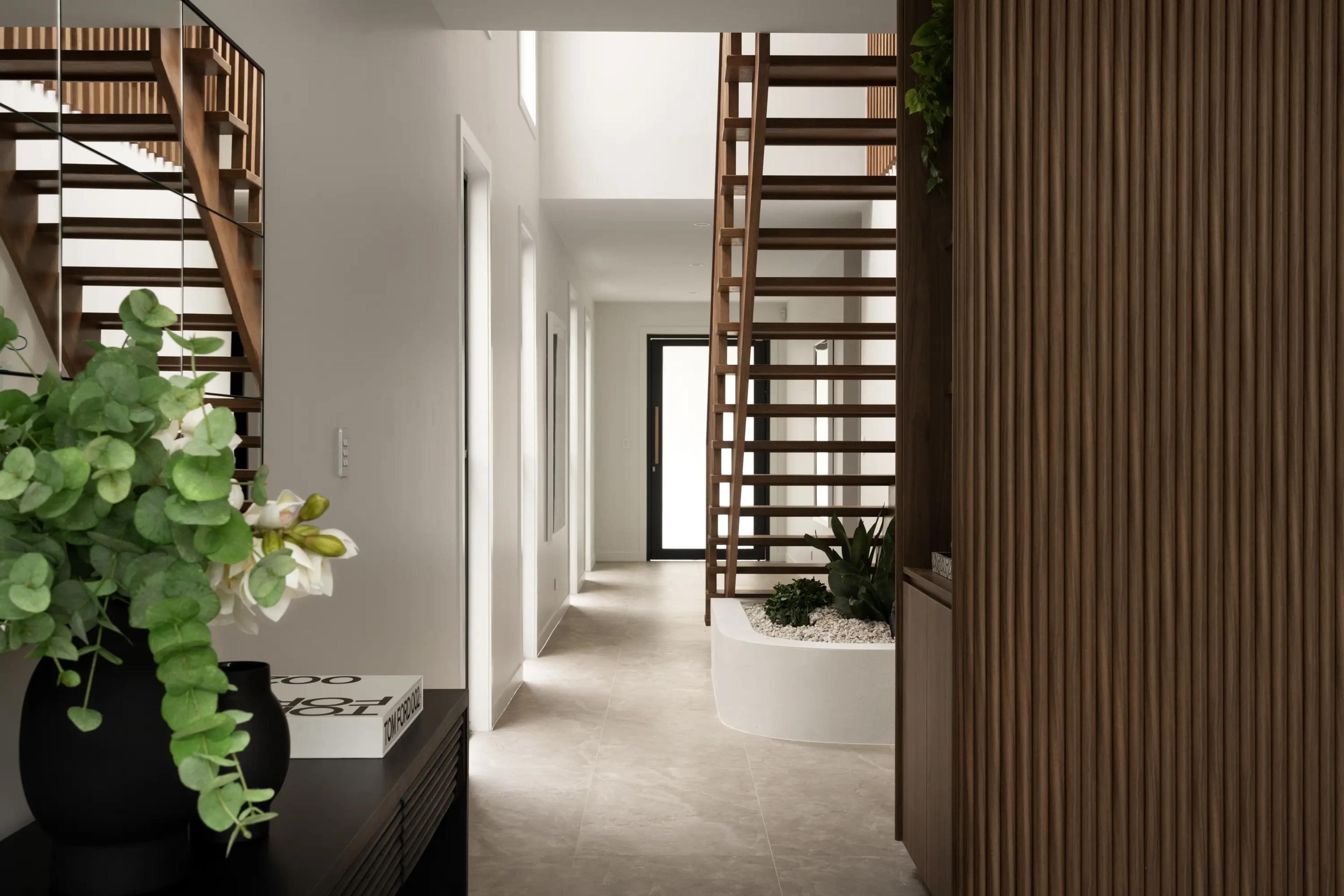 Entry hallway with timber staircase and planter