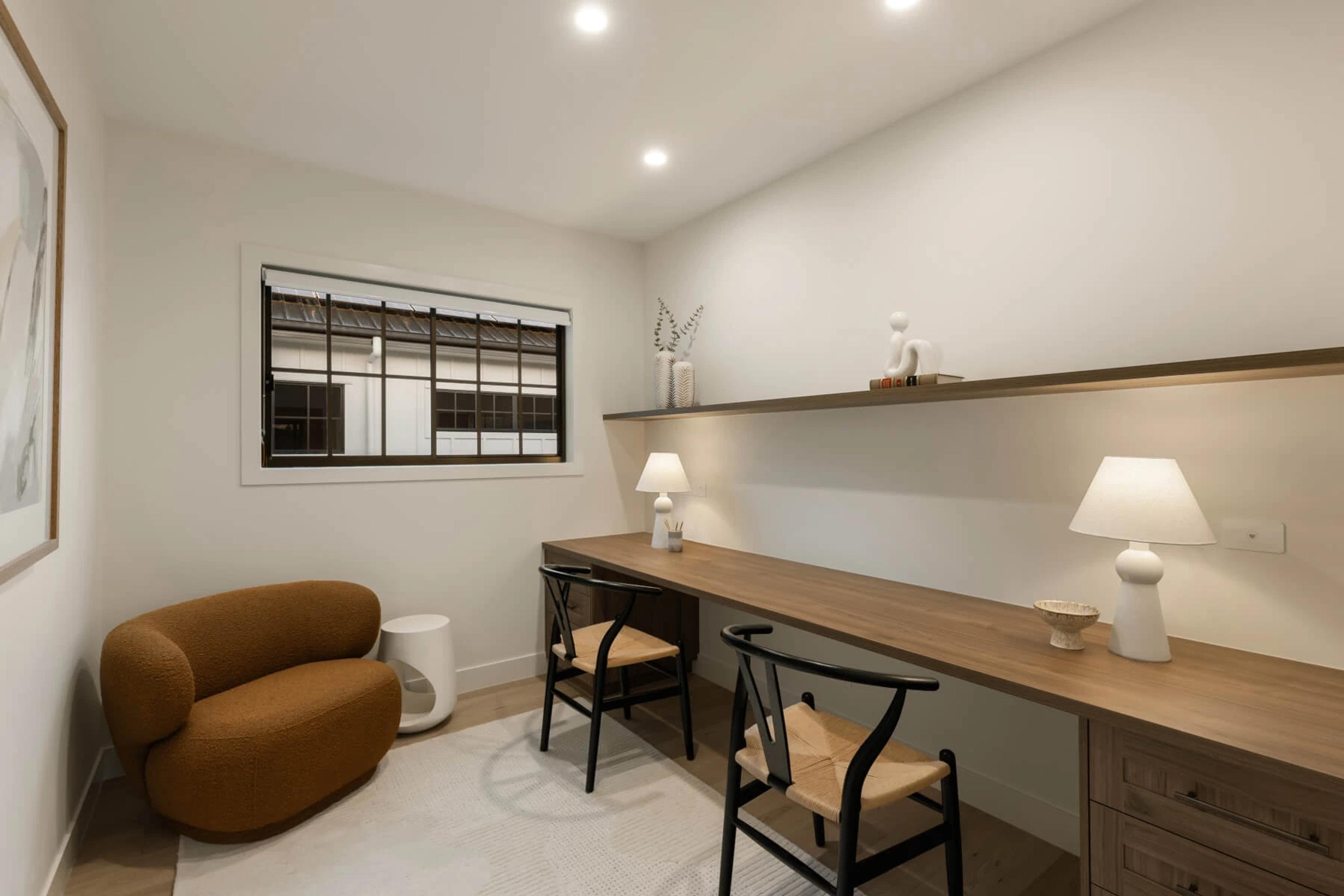 Study nook with timber desk, wishbone chairs and shelving