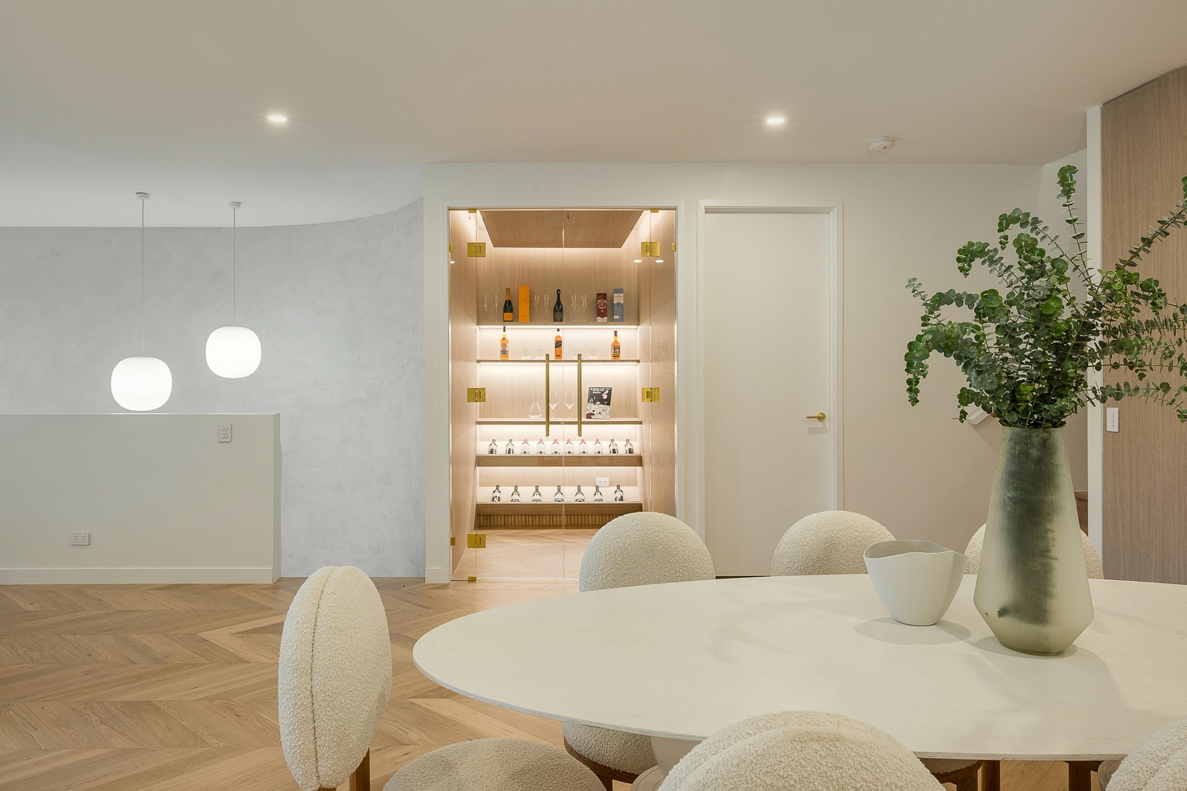 Dining area with round table and lit cellar