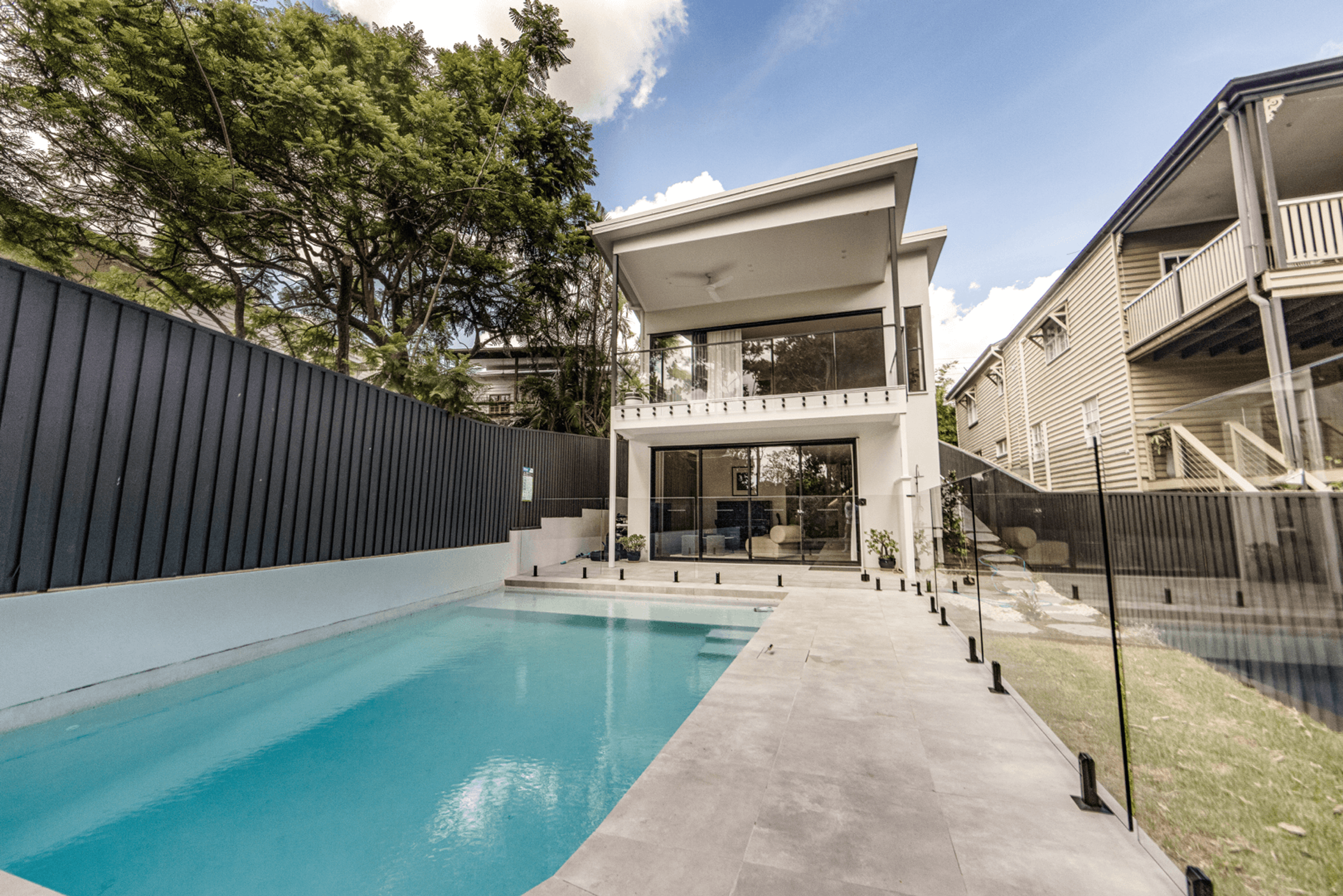 Rear exterior with swimming pool and glass fence