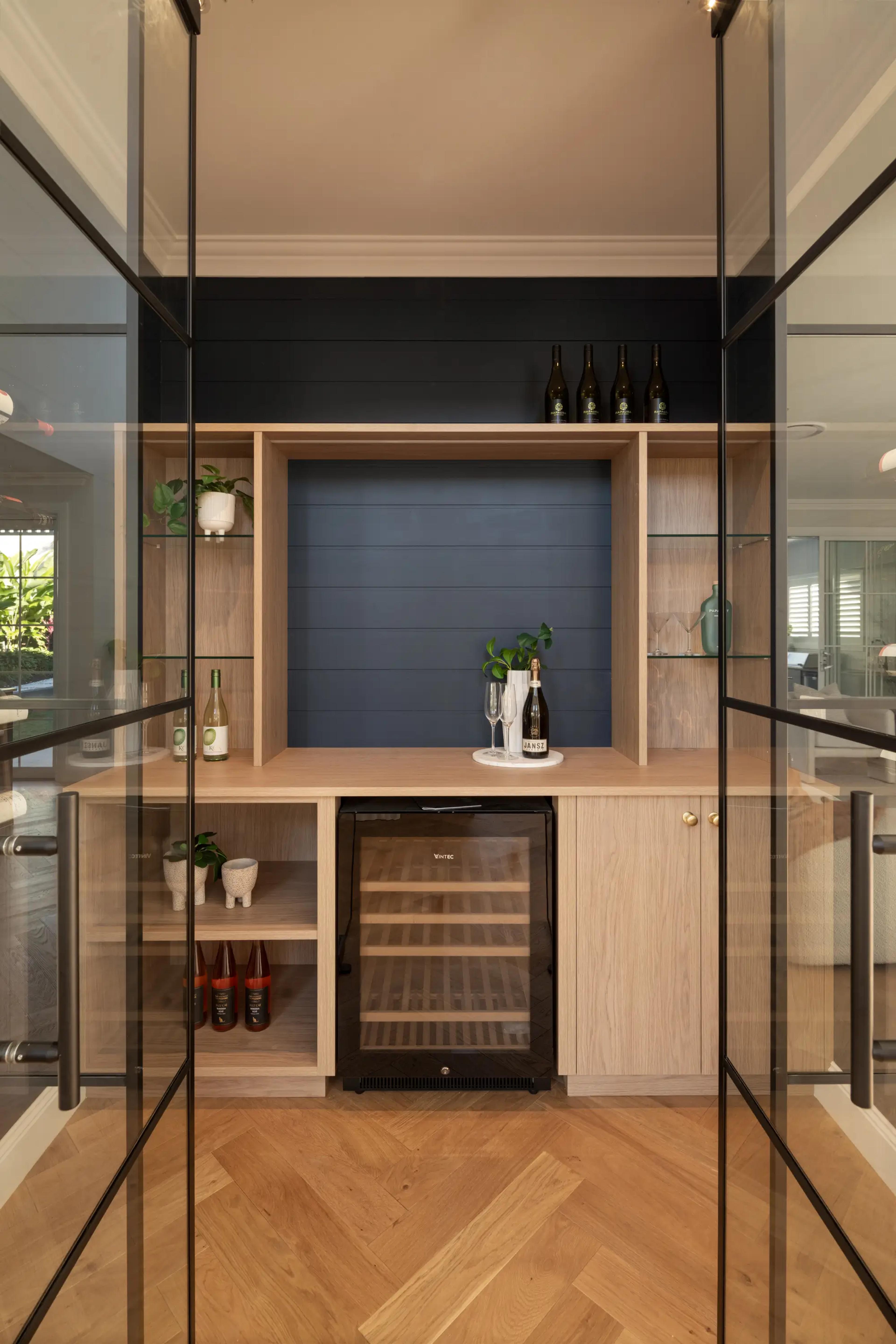 Timber drinks cabinet with wine fridge behind glass doors