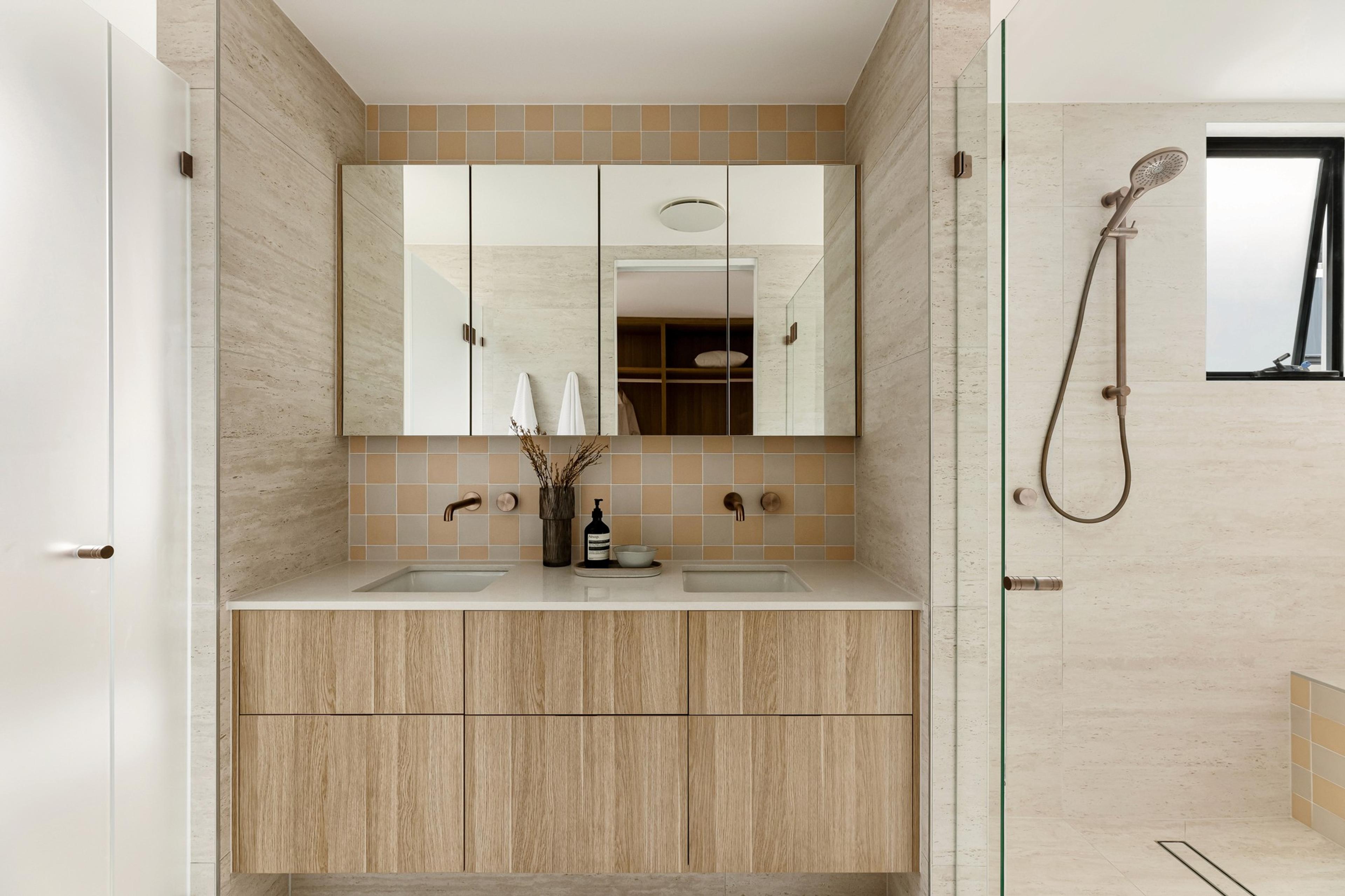 Ensuite double vanity with mirrored cabinets and adjoining shower