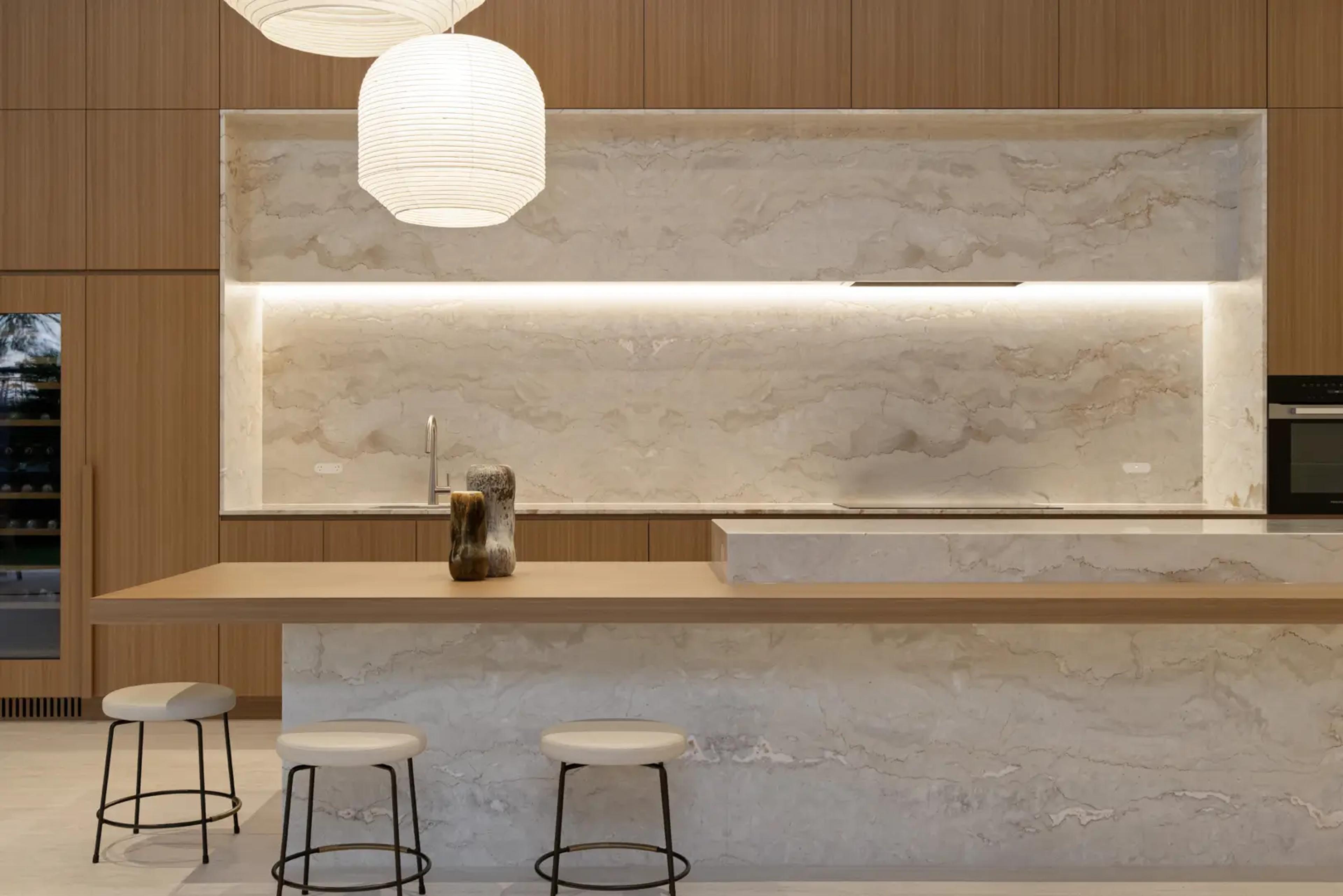 Kitchen with marble island bench and timber joinery
