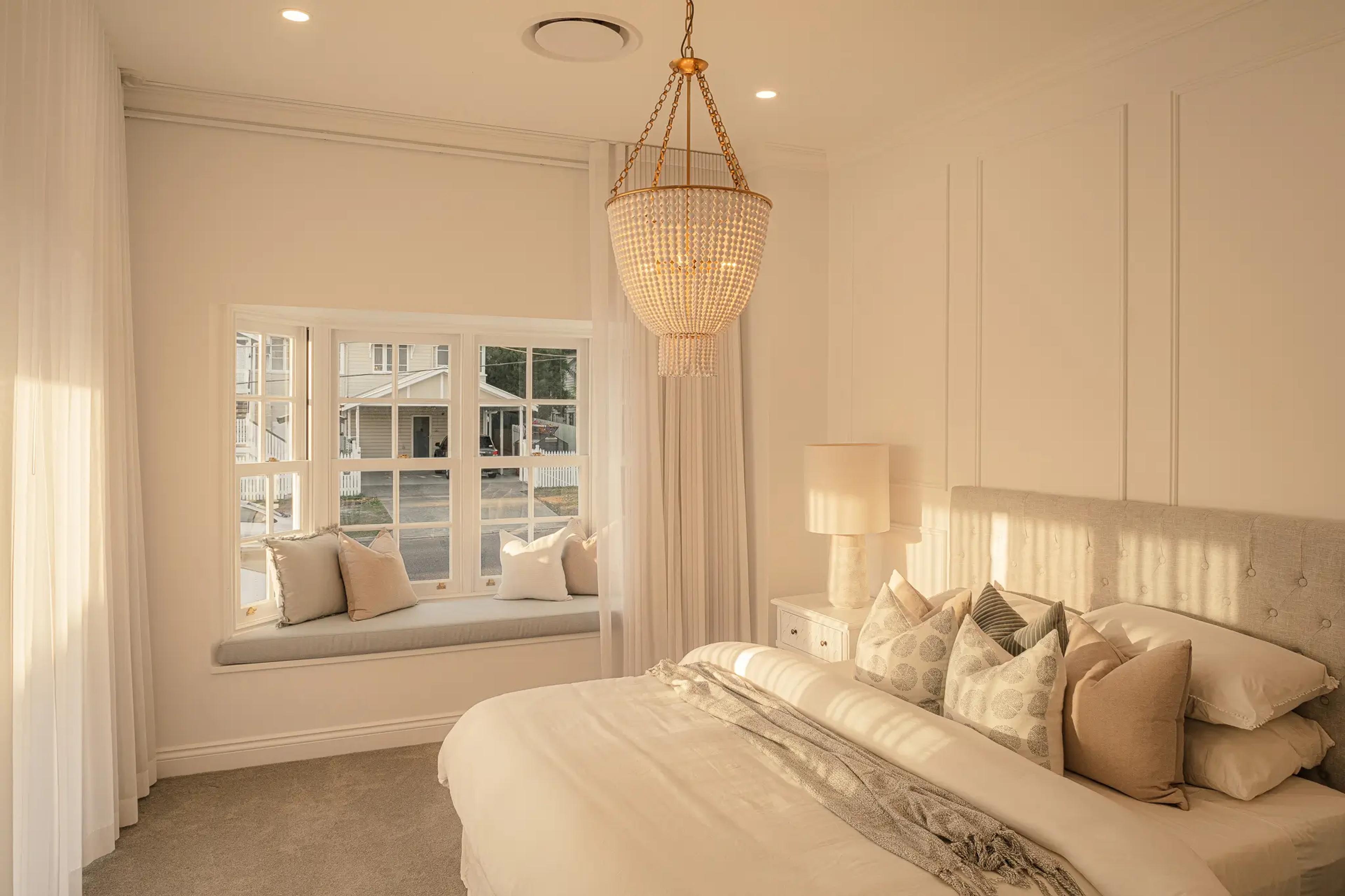 Luxurious master bedroom retreat with a custom window seat