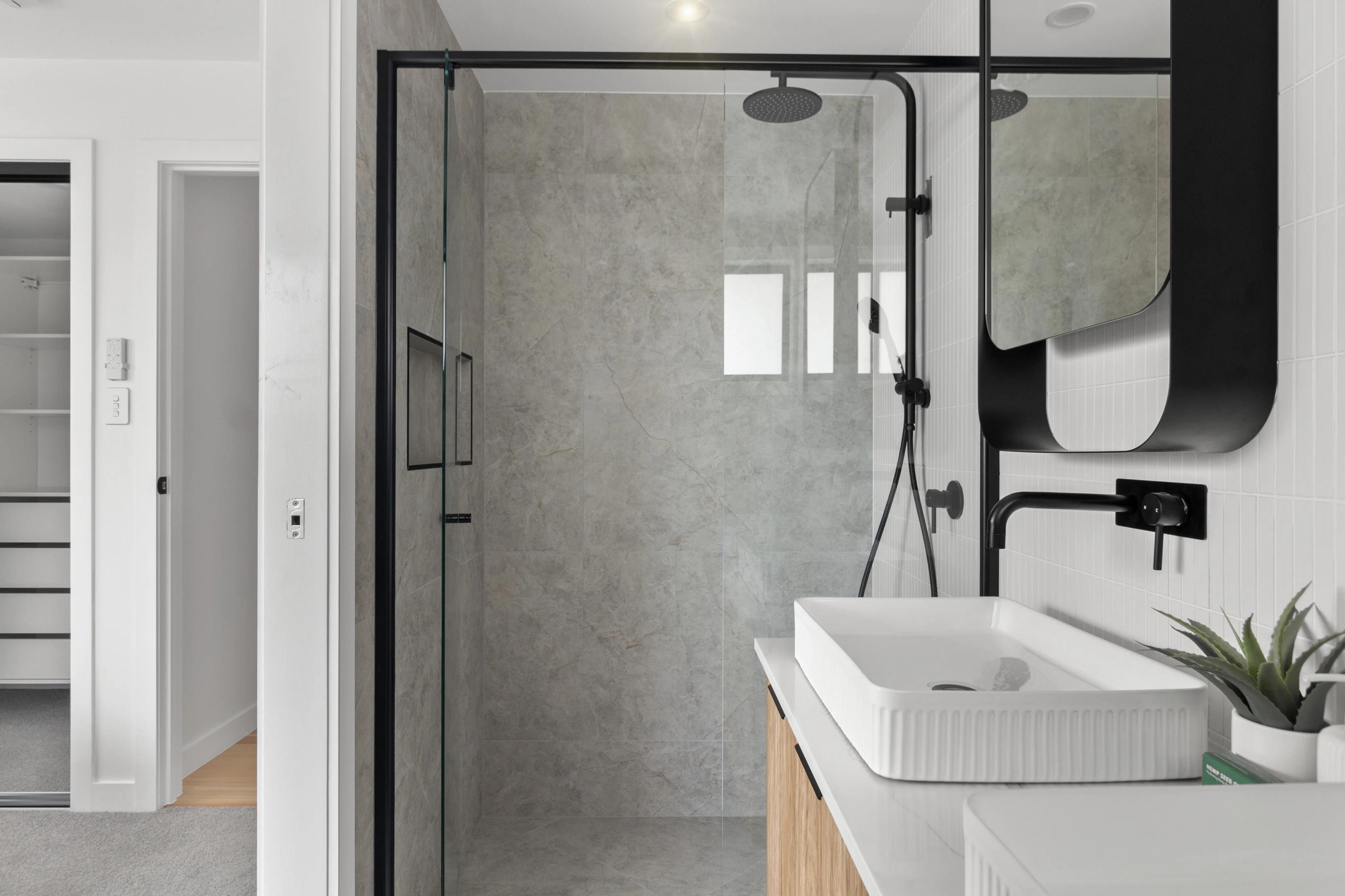 Bathroom with walk in shower, stone tiles and timber vanity