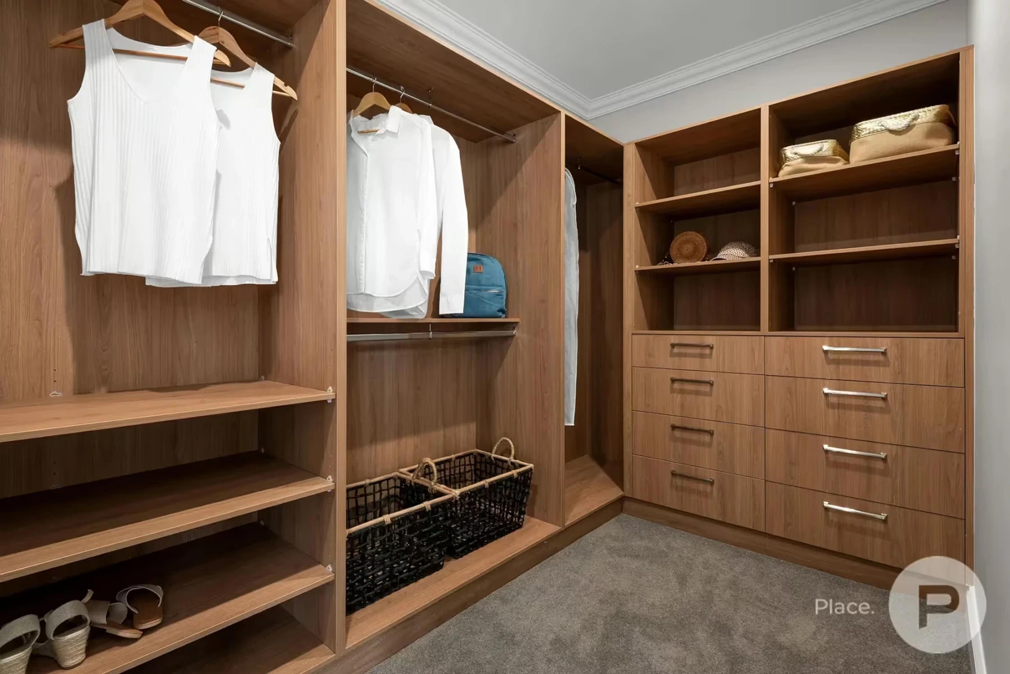 Timber walk in wardrobe with shelving and drawers