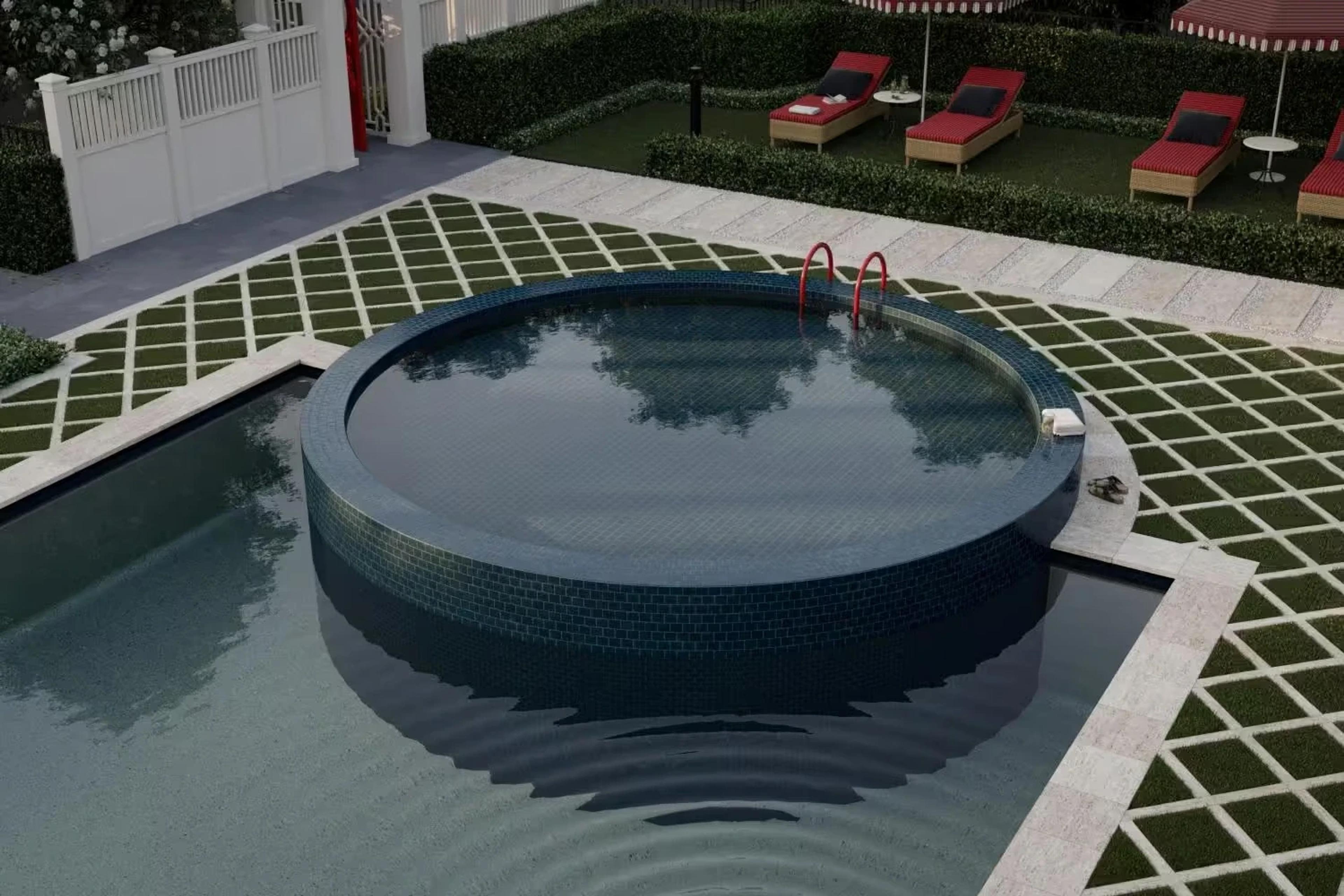 Close view of circular spa beside a rectangular pool