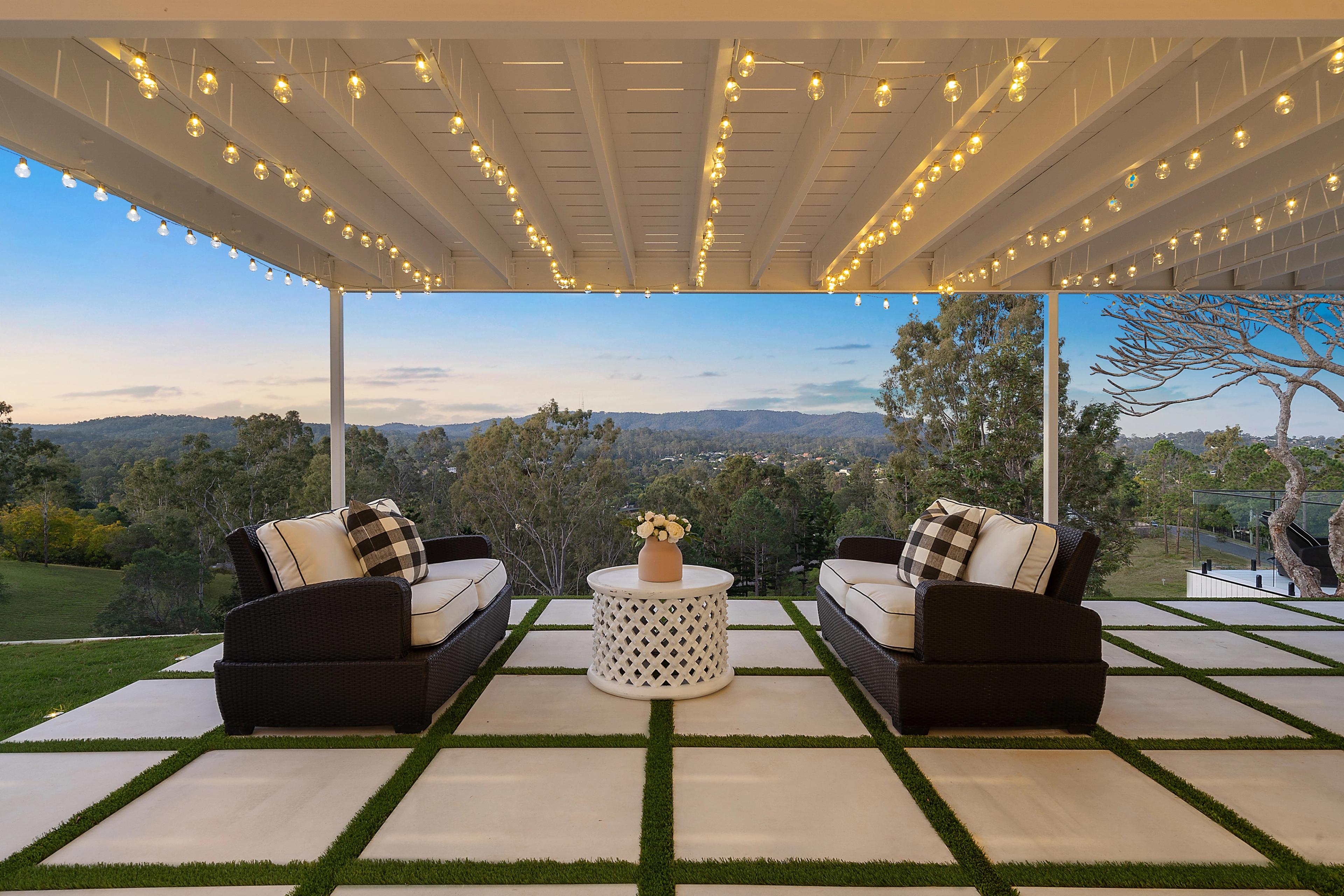 Covered terrace under the upper deck with festoon lighting and valley views