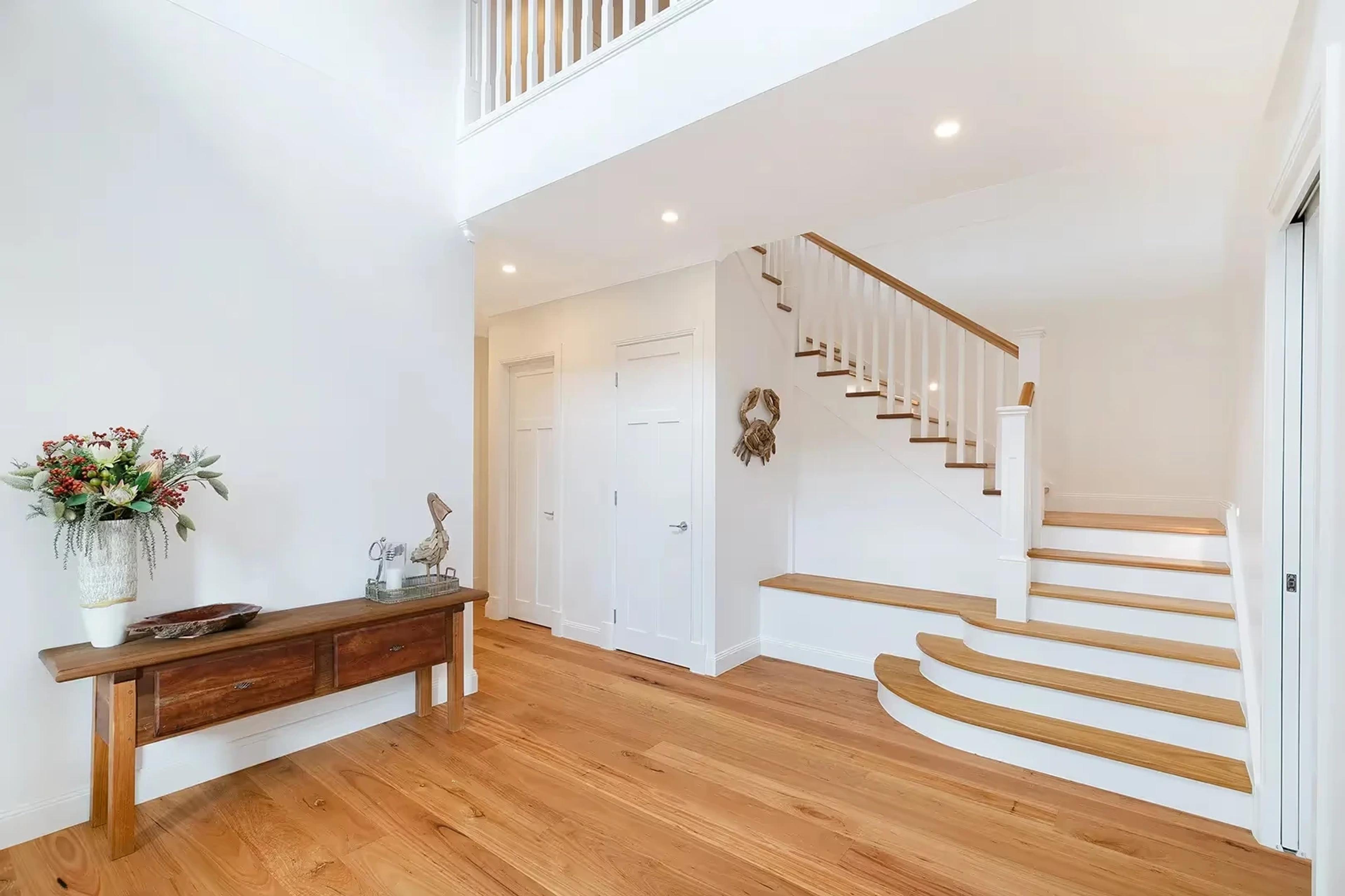 Entry hall with timber floors and staircase