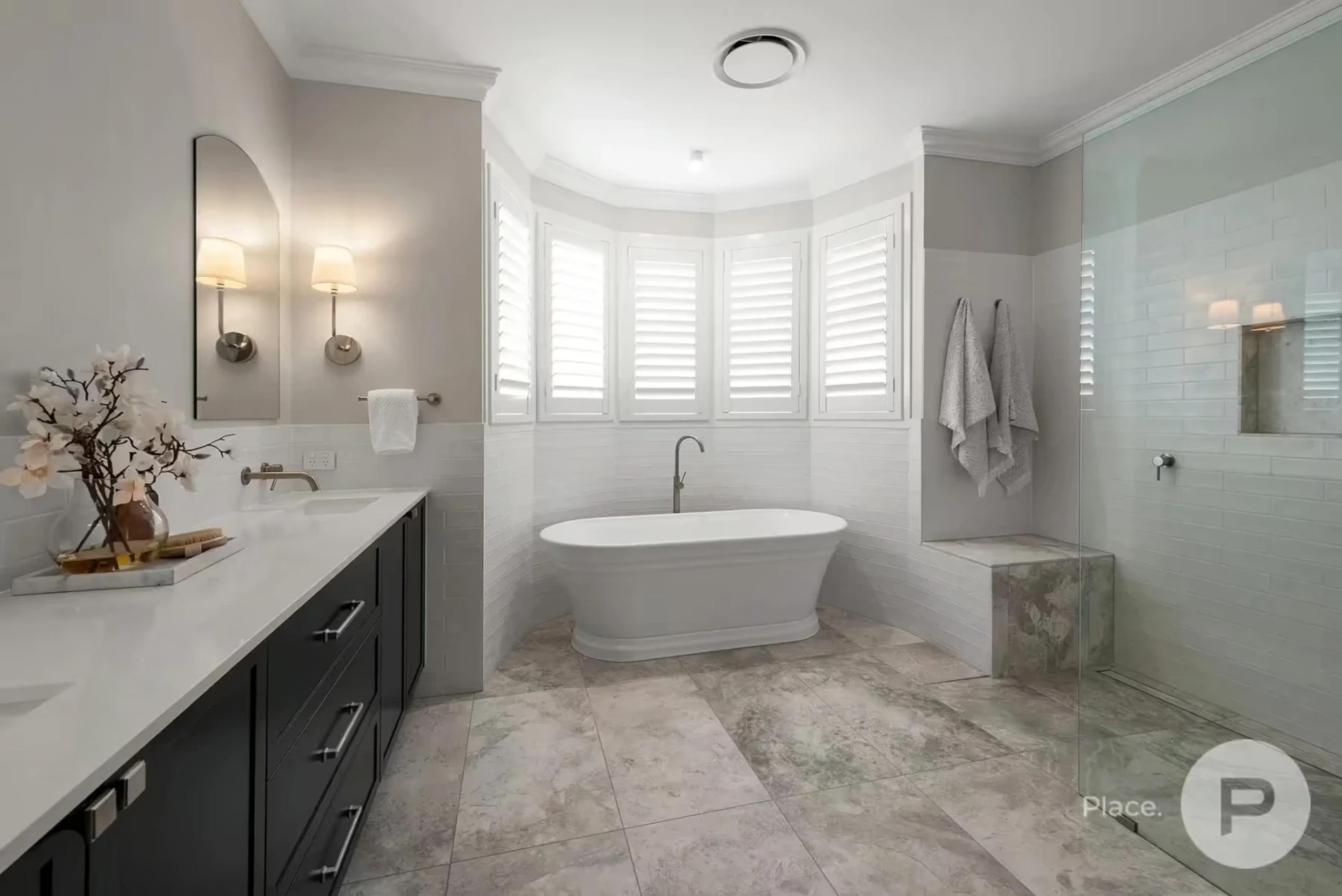 Main bathroom with freestanding bath and plantation shutters